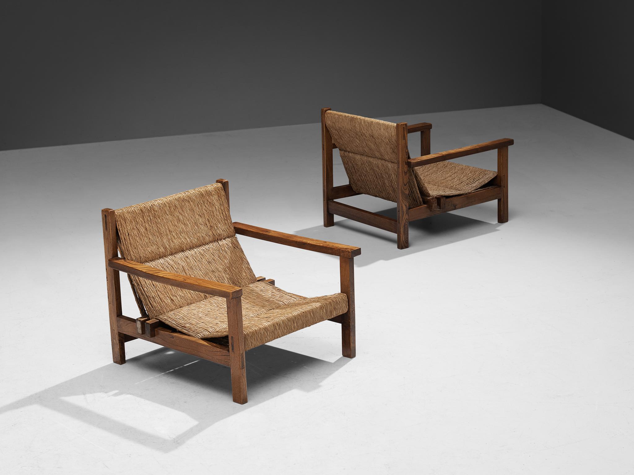 Pair of armchairs, stained elm, straw, Spain, 1950s.

These beautifully constructed armchairs conceal an evolved rustic character with great quality of elegance. The wooden frame features a solid construction of straight lines and round corners.