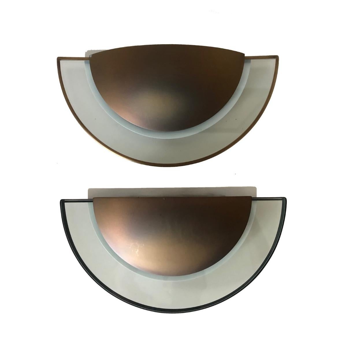 Postmodern and stunning set of two metal and glass wall sconces. These wall sconces were made in Barcelona (Spain) by Estiluz during 1980s.
The Estiluz design studio led by Leonardo Marelli was created in 1969.
“Estiluz” original sticker label
