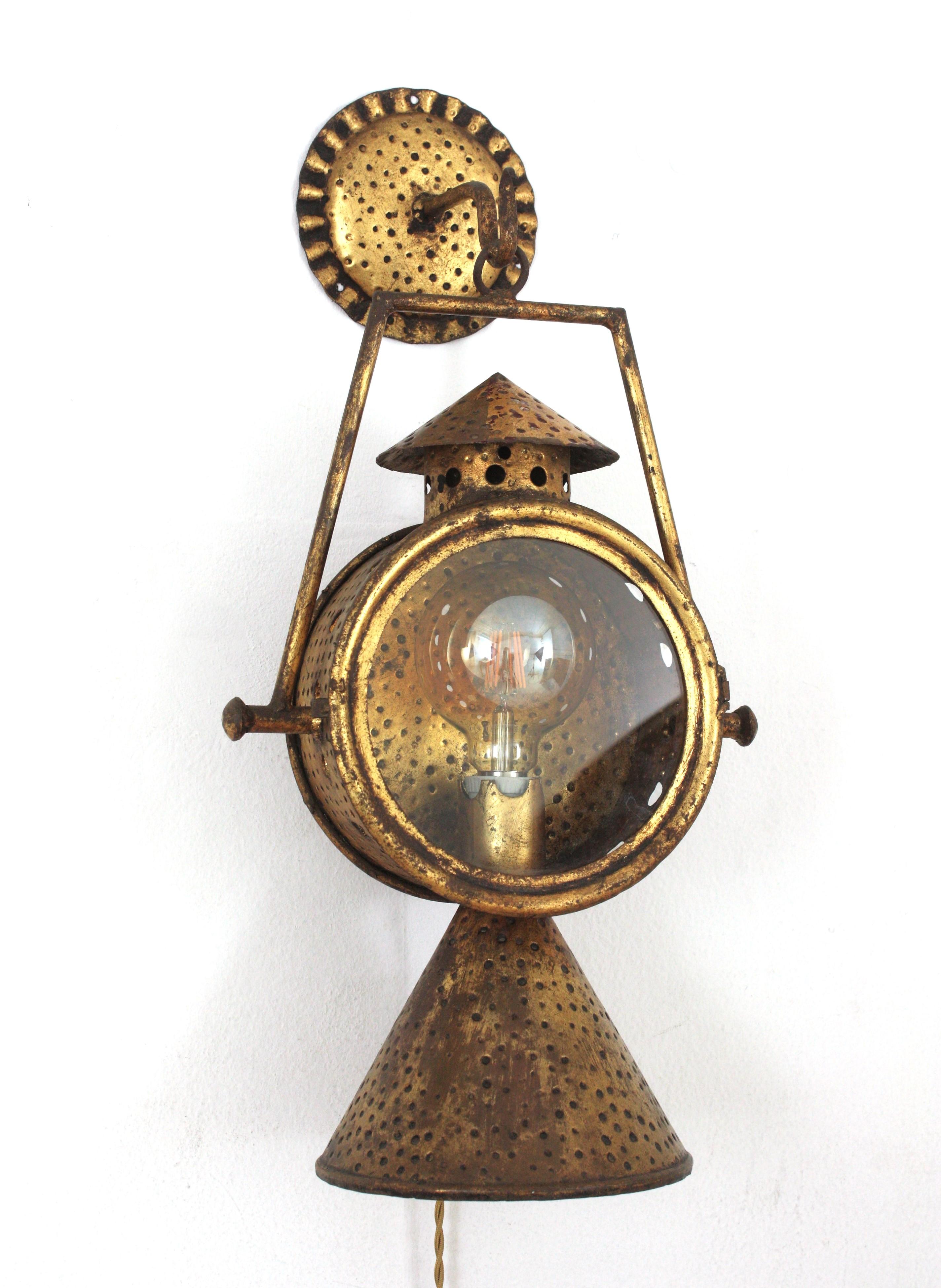 Unusual Spanish Train Station Railway Wall Hanging Lantern, Gilt Iron
Spain, 1940s
Eye-catching wall mounted hanging railway wall sconce handcrafted in iron and finished in gold leaf gilding. Heavily adorned by the hammer work thorough.
Rare