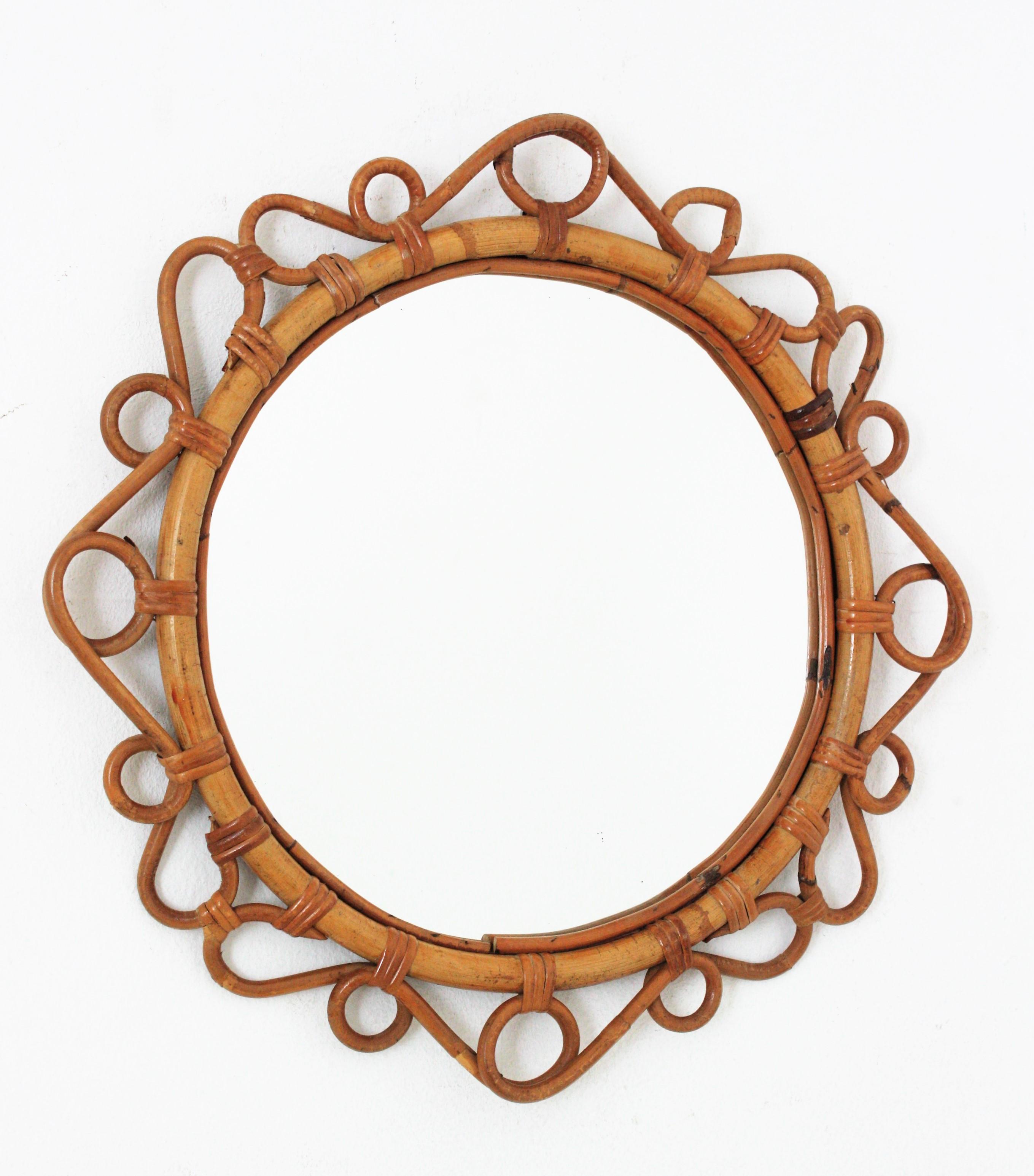 Eye-catching handcrafted bamboo and rattan oval mirror with scroll detailing surrounding the frame. Spain, circa 1960s.
This Mediterranean wall mirror features an oval bamboo frame surrounded by rattan scroll and circle decorations.
It will add a