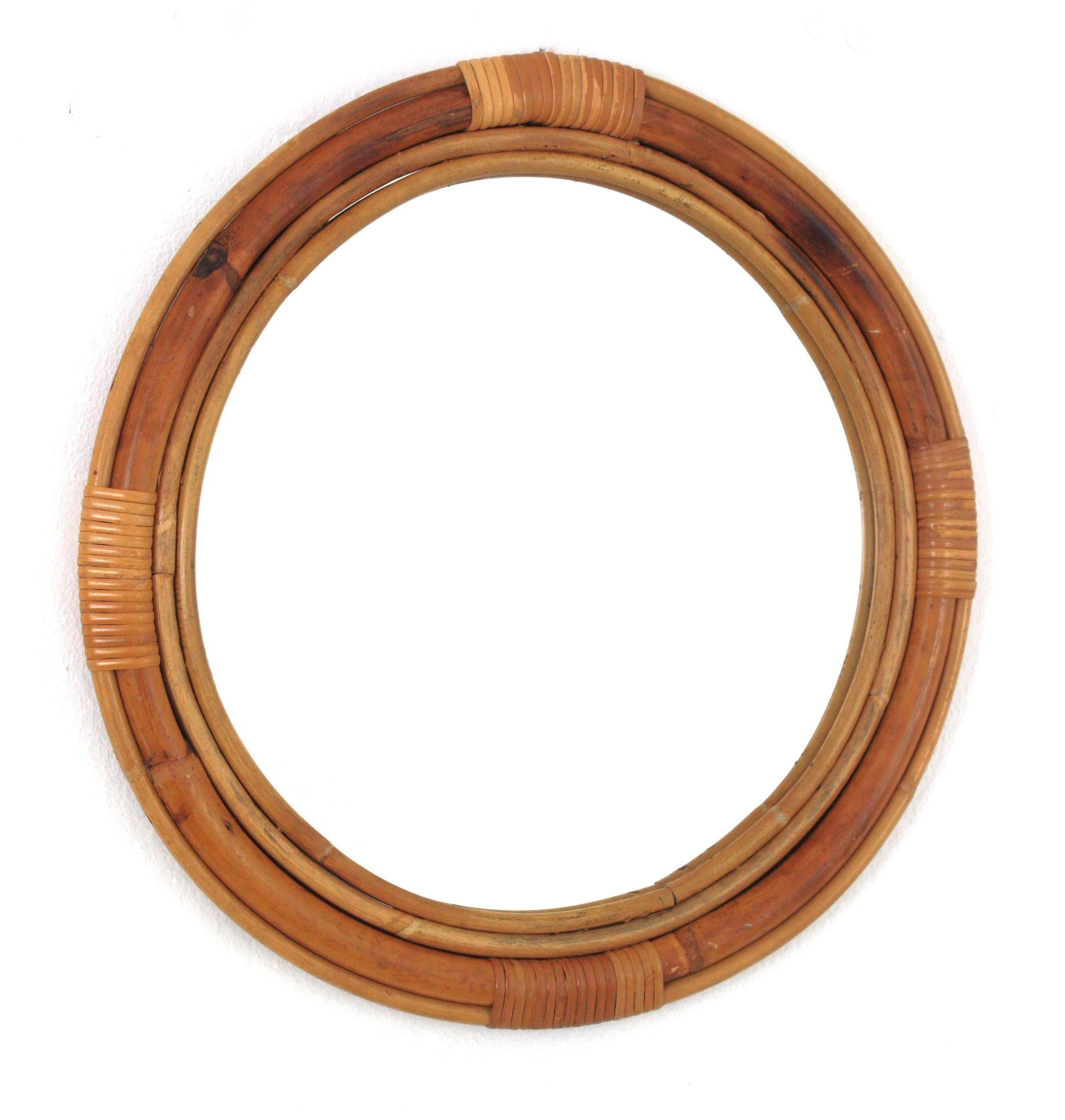 Eye-catching Mid-Century Modern round bamboo rattan wall mirror, Spain, 1950s-1960s
Wrapped tied wicker details on the top, bottom and both sidez.
This mirror has reminiscences of Paul Frankl designs.
Concentric tiers of rattan and bamboo canes with