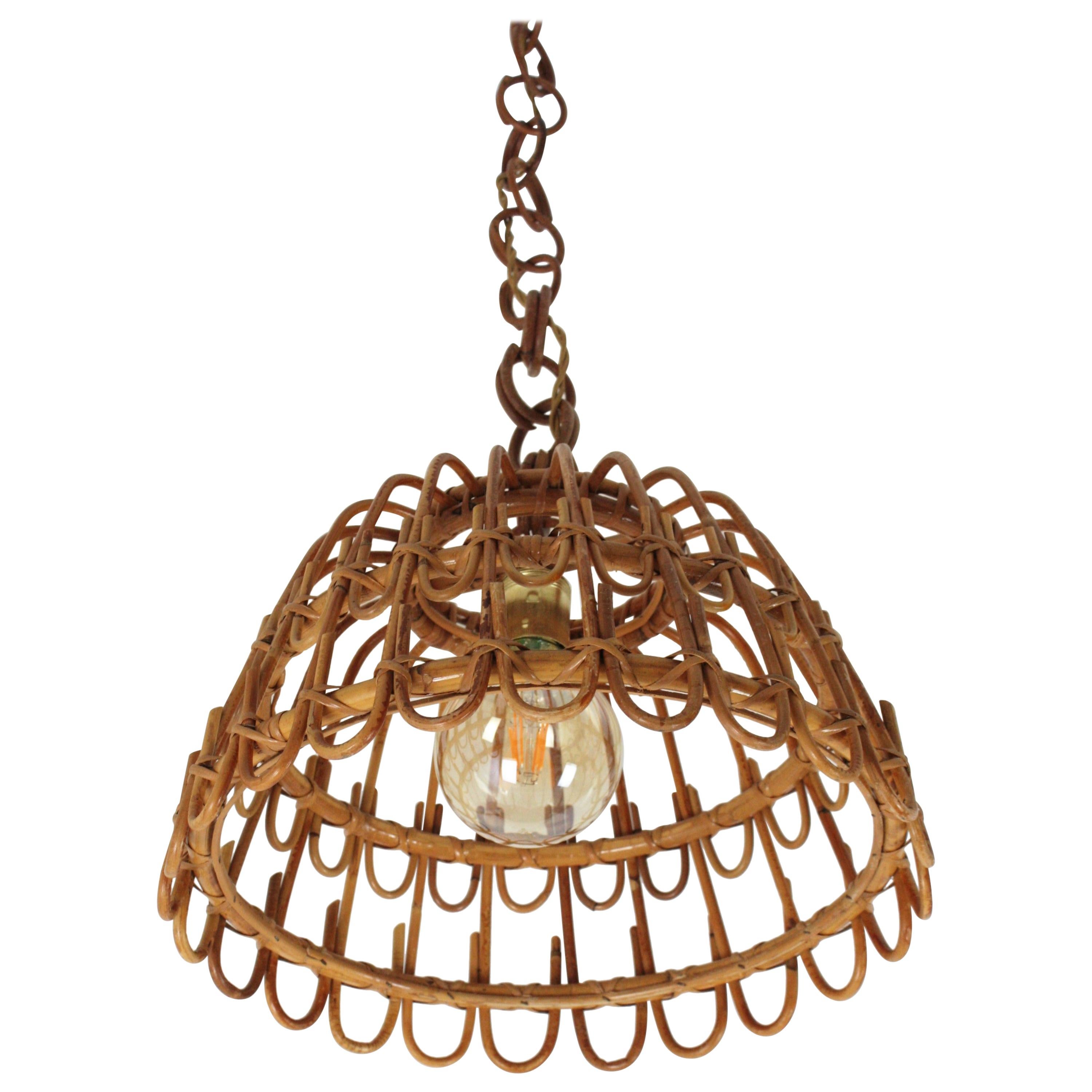 Eyecatching handcrafted rattan /wicker pendant light with geometric petal design. Spain, 1960s. 
This suspension lamp hangs from a rattan / bamboo chain that can be adjusted removing some links to the desired height.
This lamp will add a fresh