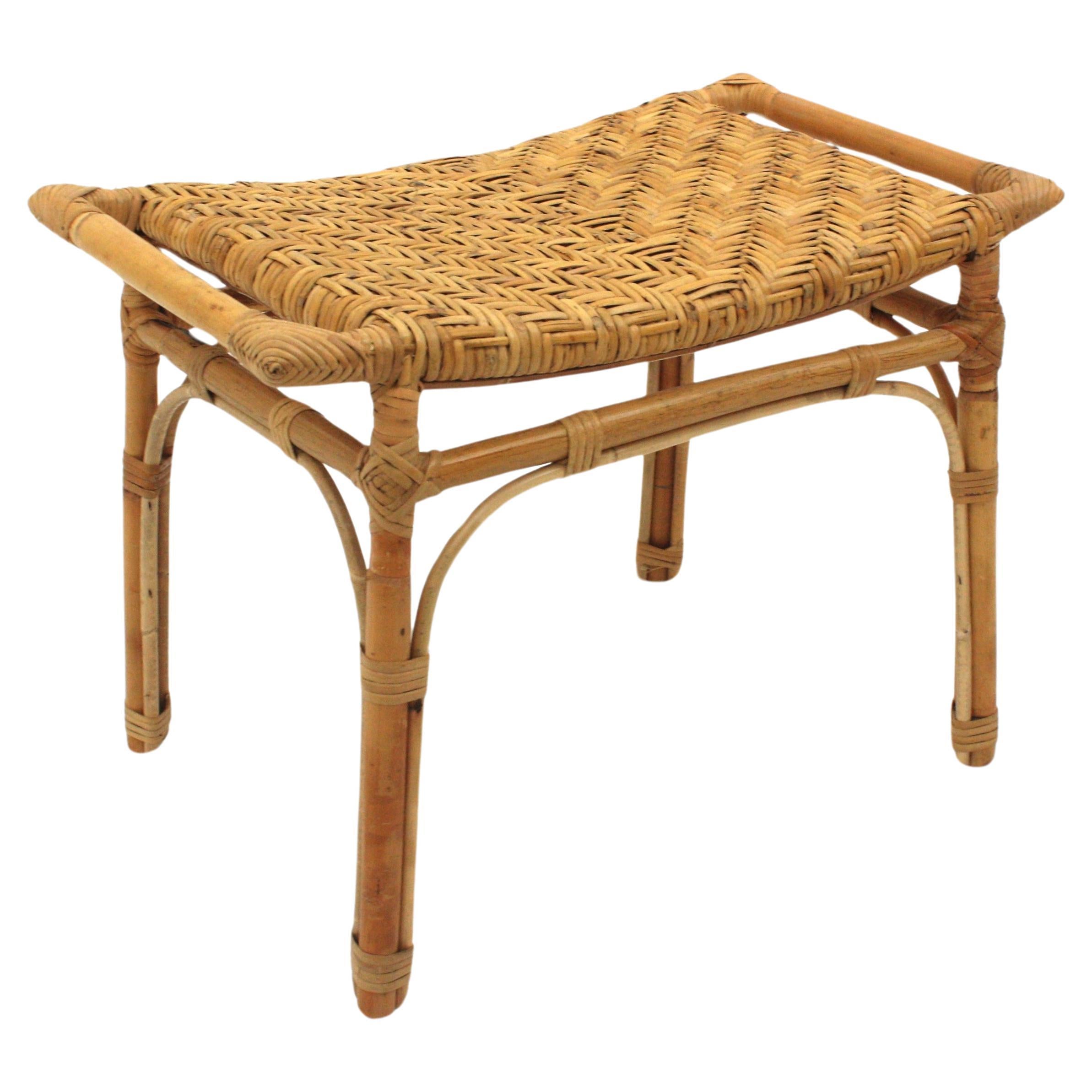 Eyecatching handcrafted bamboo and woven wicker cane stool / side table.
This Mid-Century Modernist bamboo and woven rattan / wicker rectangular stool or small bench was handcrafted in Spain near 1960s.
Design with handles at both sides inspired in