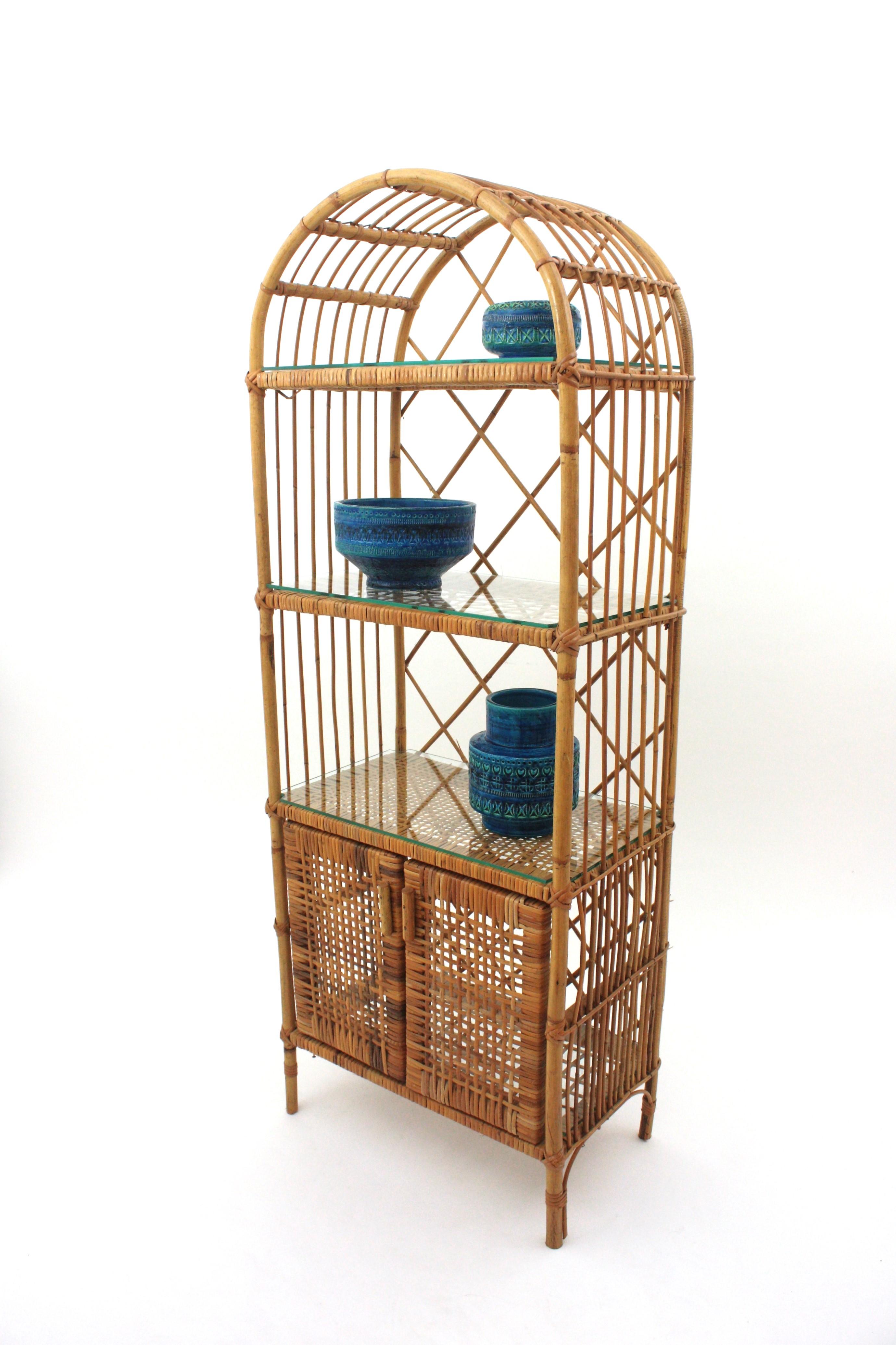 Eye-catching Rattan Storage Tall Cabinet or Bookcase / Bookshelf, Spain, 1960s
This rattan cabinet features a rattan structure with woven wicker details. Round top and Four Levels: three shelves and a fourth one with doors. Each level has a glass