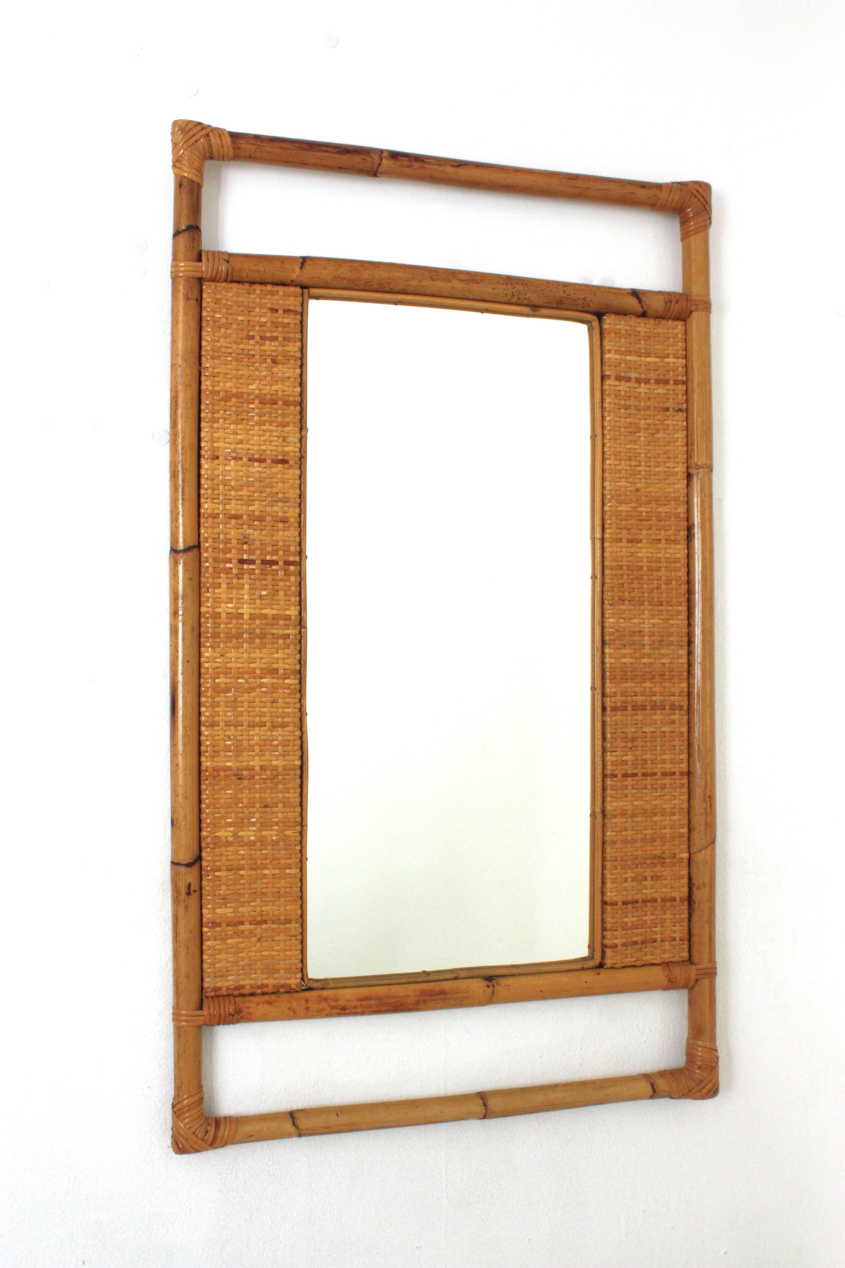 Bamboo Rattan and Woven Wicker Rectangular Mirror, Spain, 1960s.
Eye-catching Coastal rectangular mirror handcrafted rattan bamboo frame and woven wicker panels. 
Highly decorative handcrafted rattan frame with geometric design and Midcentury and