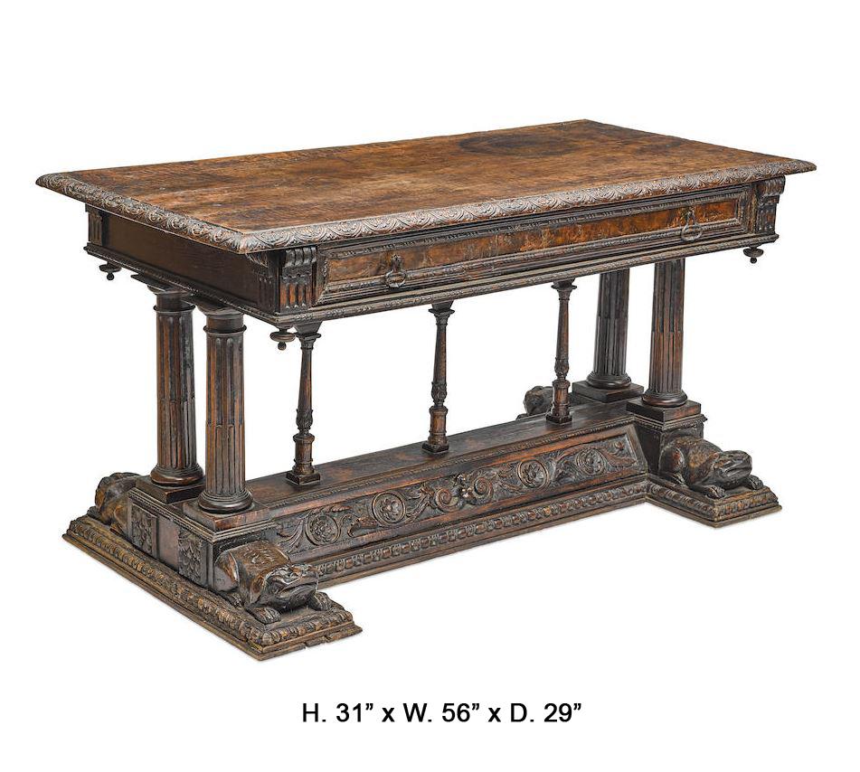 Sensational Spanish Renaissance hand carved walnut table, 17th century and later. The solid walnut top with carved trimmed edges over a frieze containing one large drawer with two bronze handles resting on four fluted columns and three small center