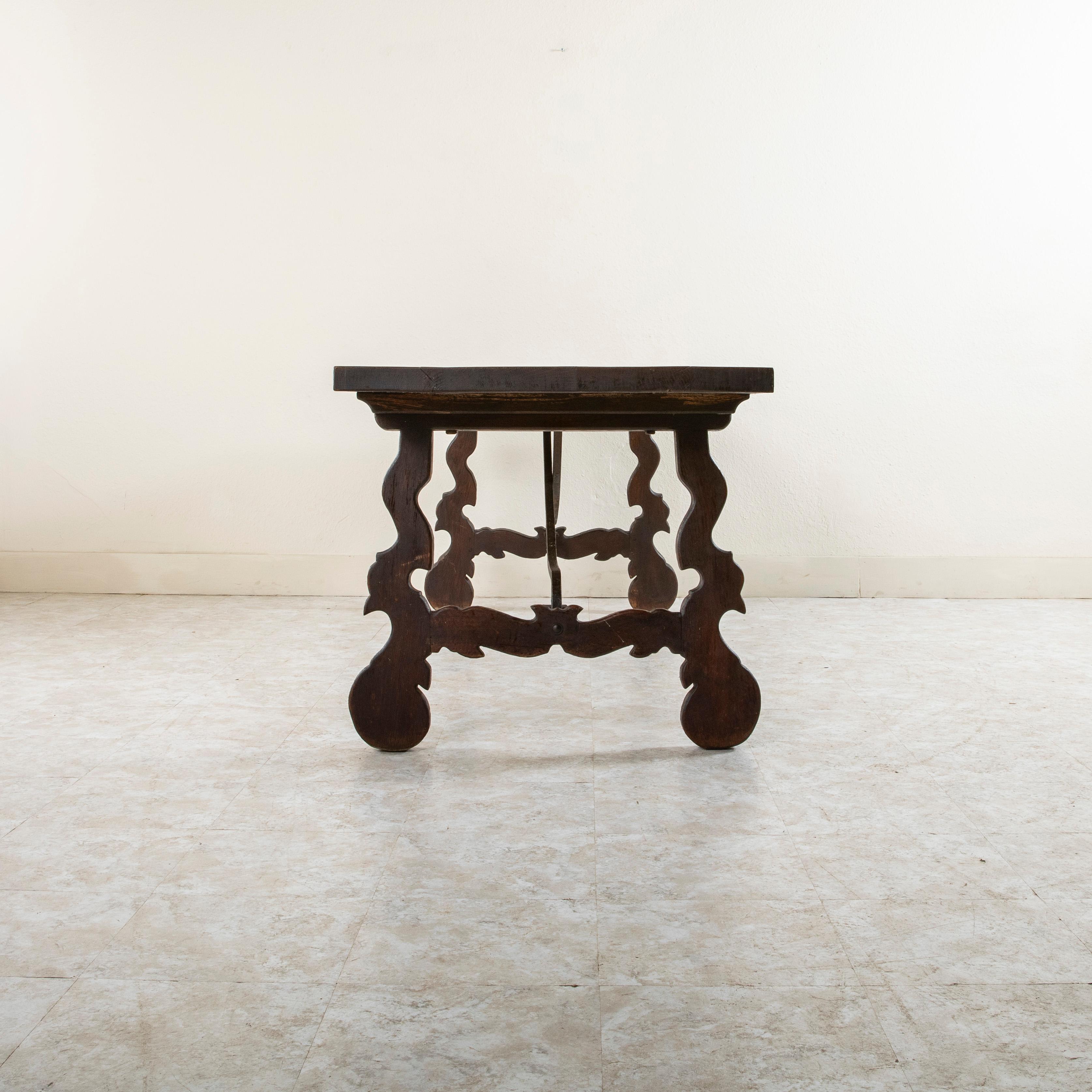 French Spanish Renaissance Style Hand Hewn Oak Table, Forged Iron Stretcher circa 1900 For Sale