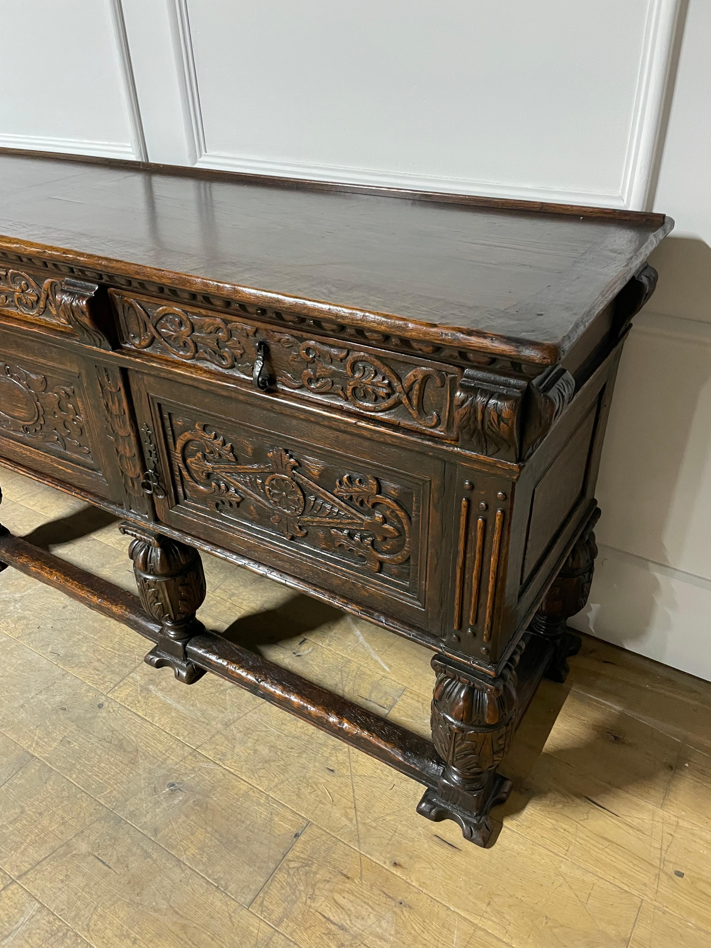 Stunning example of a late 19th Century solid oak three door side board in the renaissance style. 

Of Spanish origin dating to around the 1880’s , constructed from solid oak and having original metal work. Supplied with three keys.

H
: 94 cm