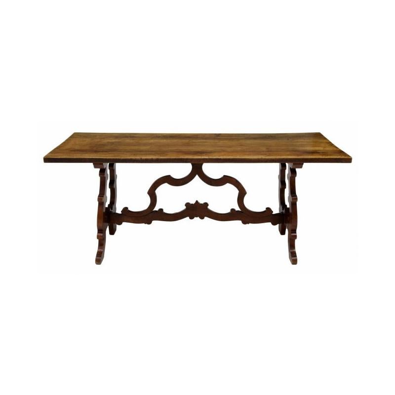 Remarkable late19th century/early 20th Spanish Renaissance style carved walnut trestle table with unusually carved stretcher. 
Very well constructed and beautifully proportioned.
