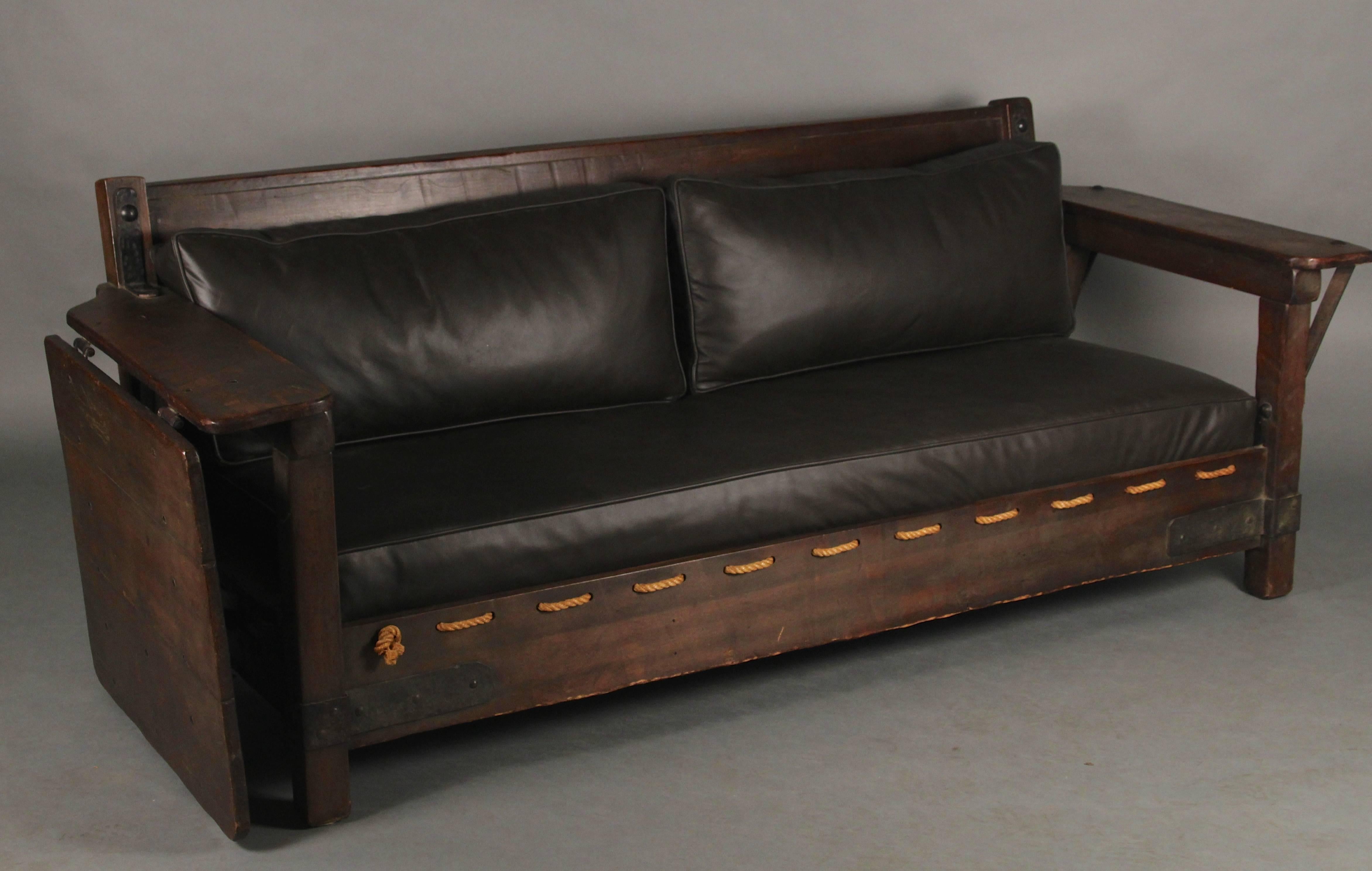 Exceptional, signed Monterey sofa in original old wood finish with hand-painted flowers on red rear panels. Great iron hardware and newly upholstered in leather. Very hard to find piece. Open, it measures 101 3/4