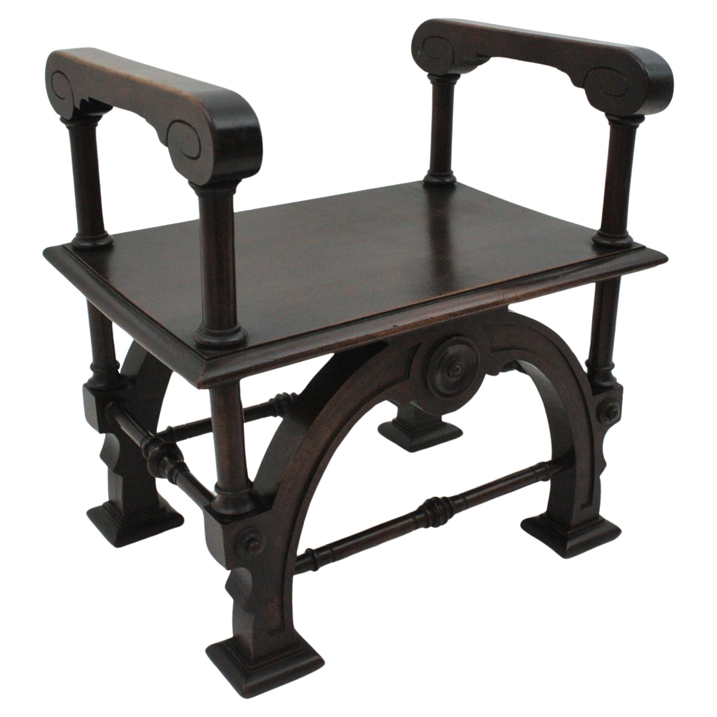Carved Walnut Curule Stool with Arms, Spain, 1930s-1940s.
Curule base with carved decorative details and arms at both sides.
To be used as stool, ottoman, night stand or occasional side table.
It will be a nice addition to any spanish revival