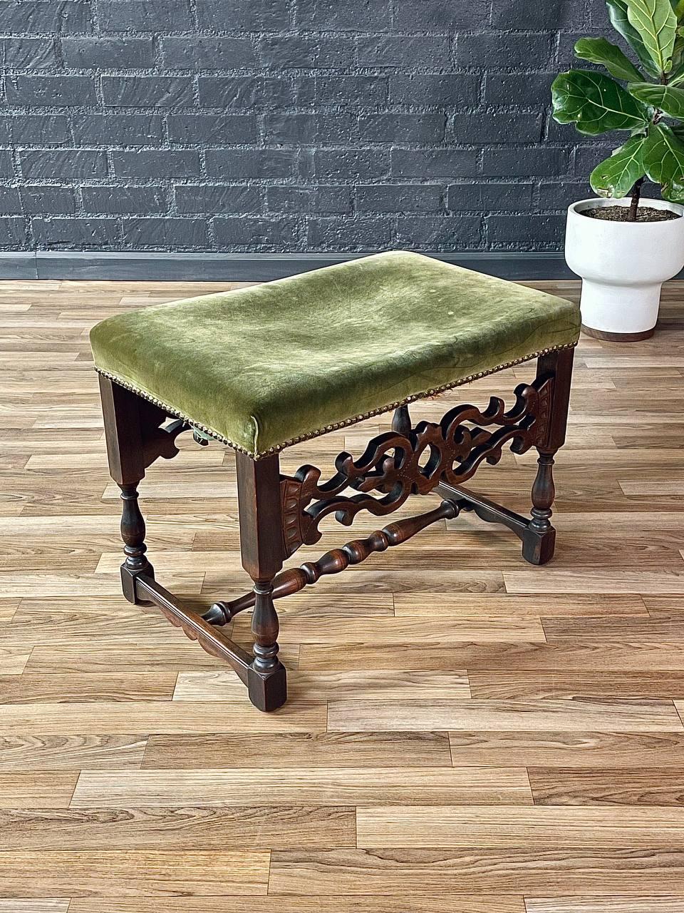 Condition: Original Vintage Condition, New Upholstery Recommended 

Materials: Walnut-Stained Mahogany, Original Green Velvet Upholstery 

This 1940s Spanish Revival Carved Wood & Velvet Stool exudes Old World charm with its hand-carved