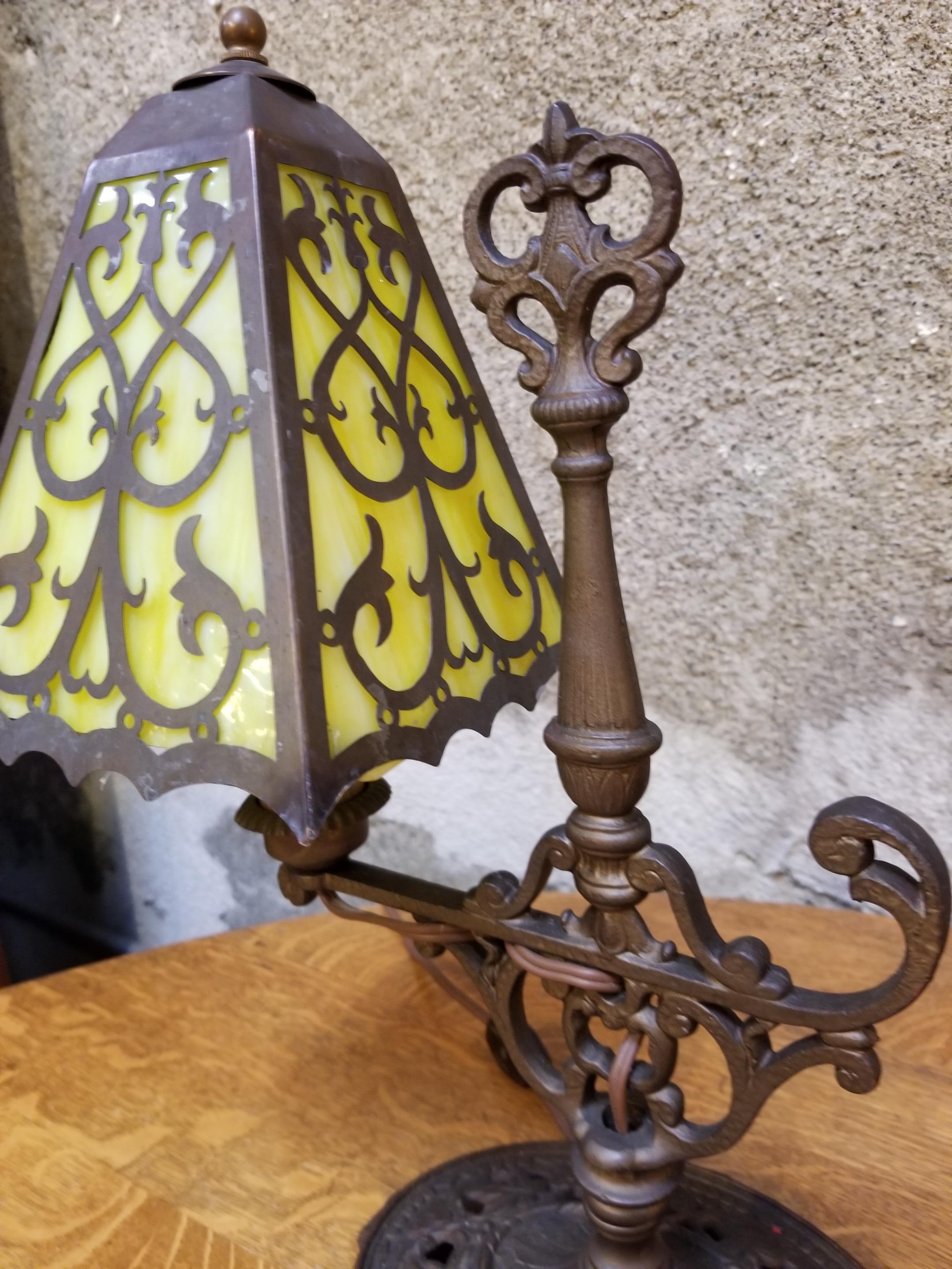 Exquisite pair of 1920s cast iron table lamps with green marbleized opaque glass shades with pierce cut decoration. Designed in the manner of Oscar Bach. Made by J. J. Braze & Company, New York, NY. Original finish and patina. Re-wired. Measure 15.5