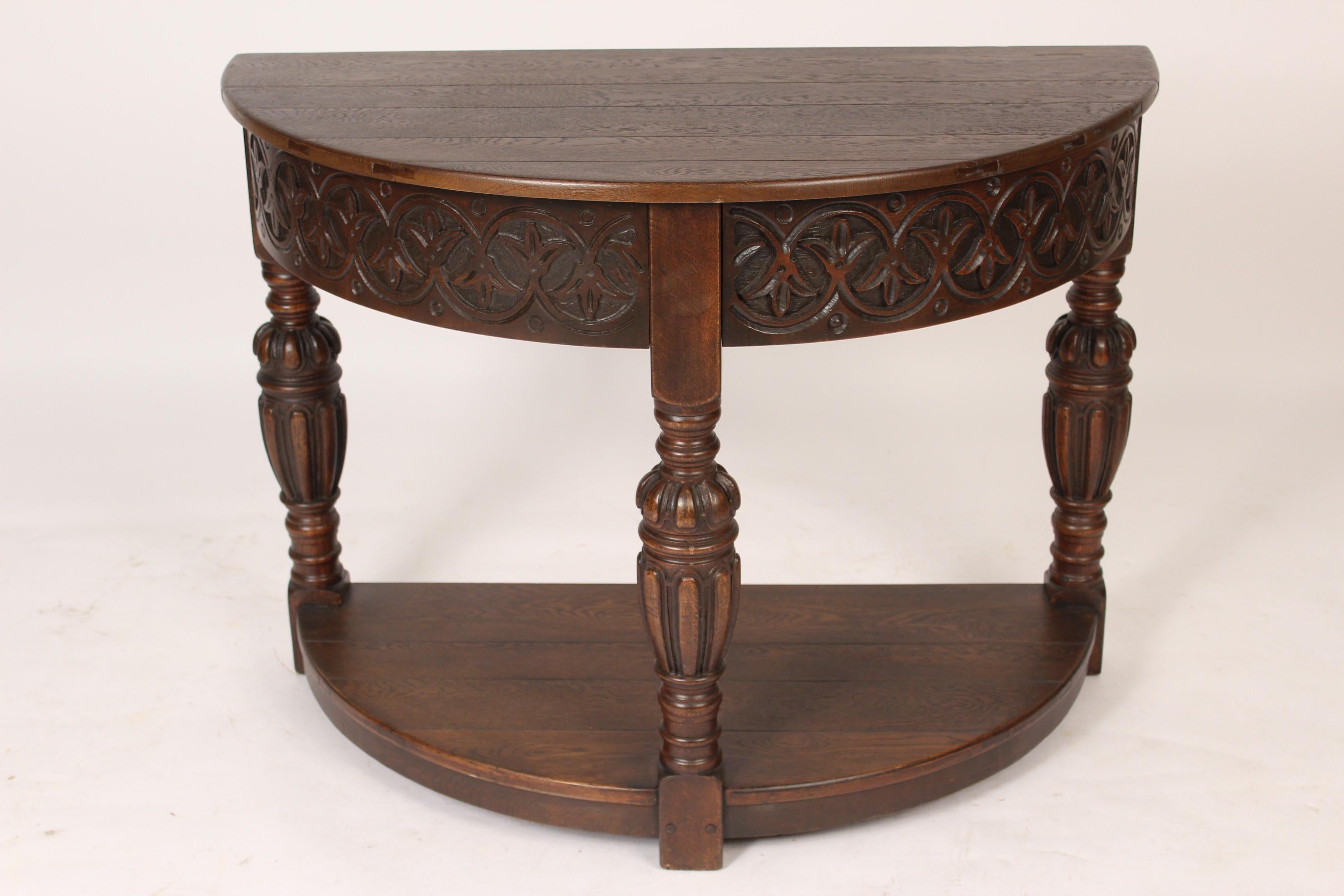 Spanish revival carved oak demilune console table, circa 1930s.