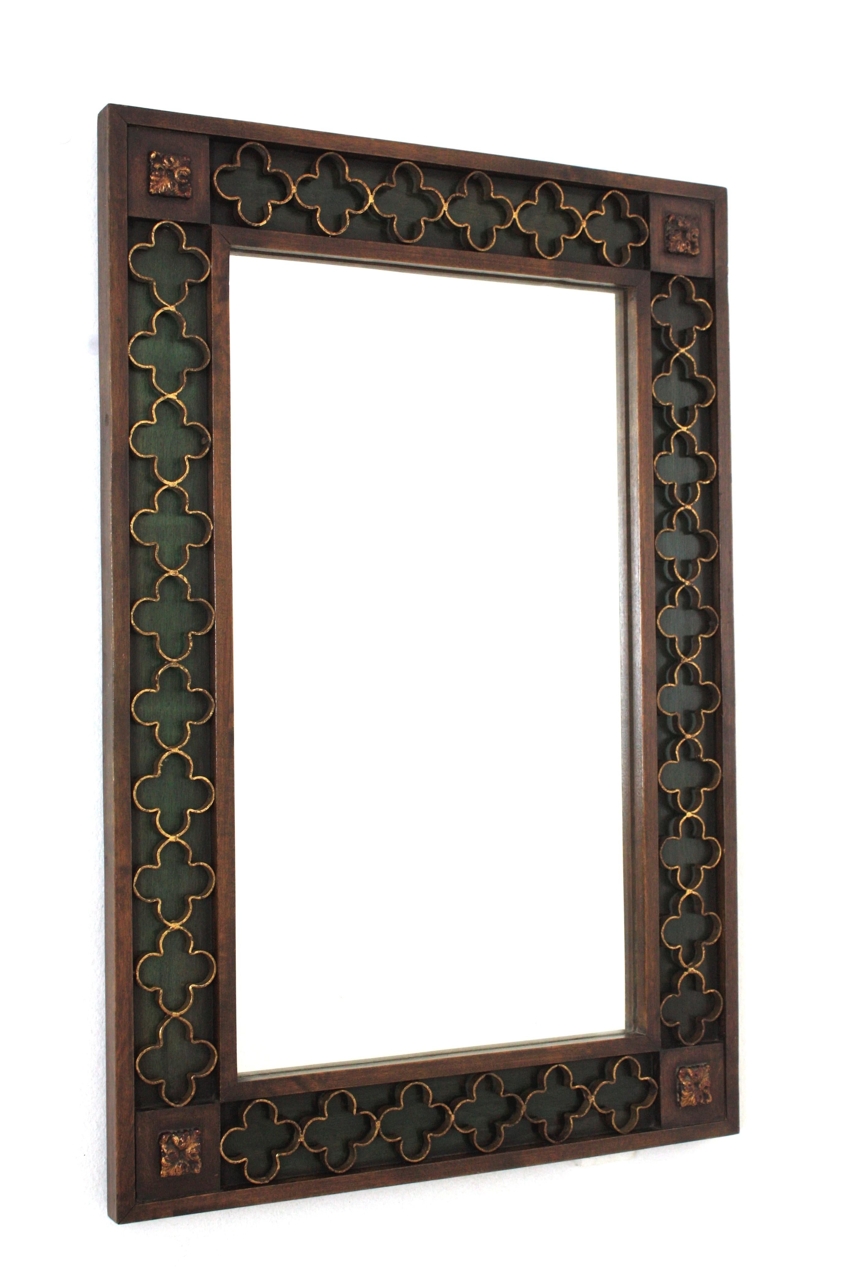 Rectangular Spanish Revival Mirror with Gilt Iron Rosettes, Spain, 1950-1960.
Beautiful rectangular frame with carving details on the corners. It has an inset frame with a green painted background and a decorative attached pattern of gilt wrought