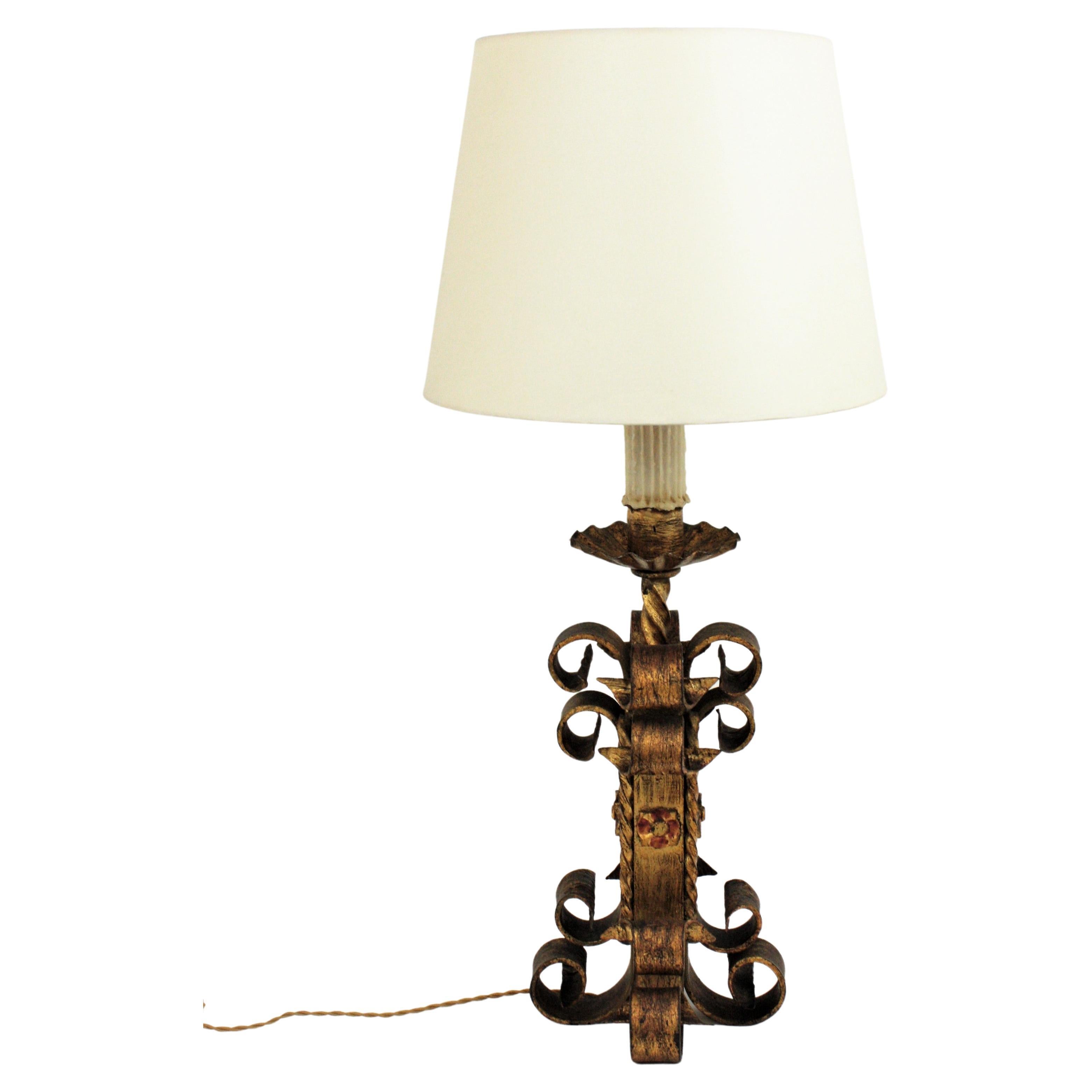 Hand-Forged Gold Leaf Gilt Iron Table Lamp with Scrollwork Design. Spain, 1940s.
This gorgeous table lamp is entirely made by hand. The base has a heavy construction made of scrolled pieces on four sides. Floral decorations and twisted details