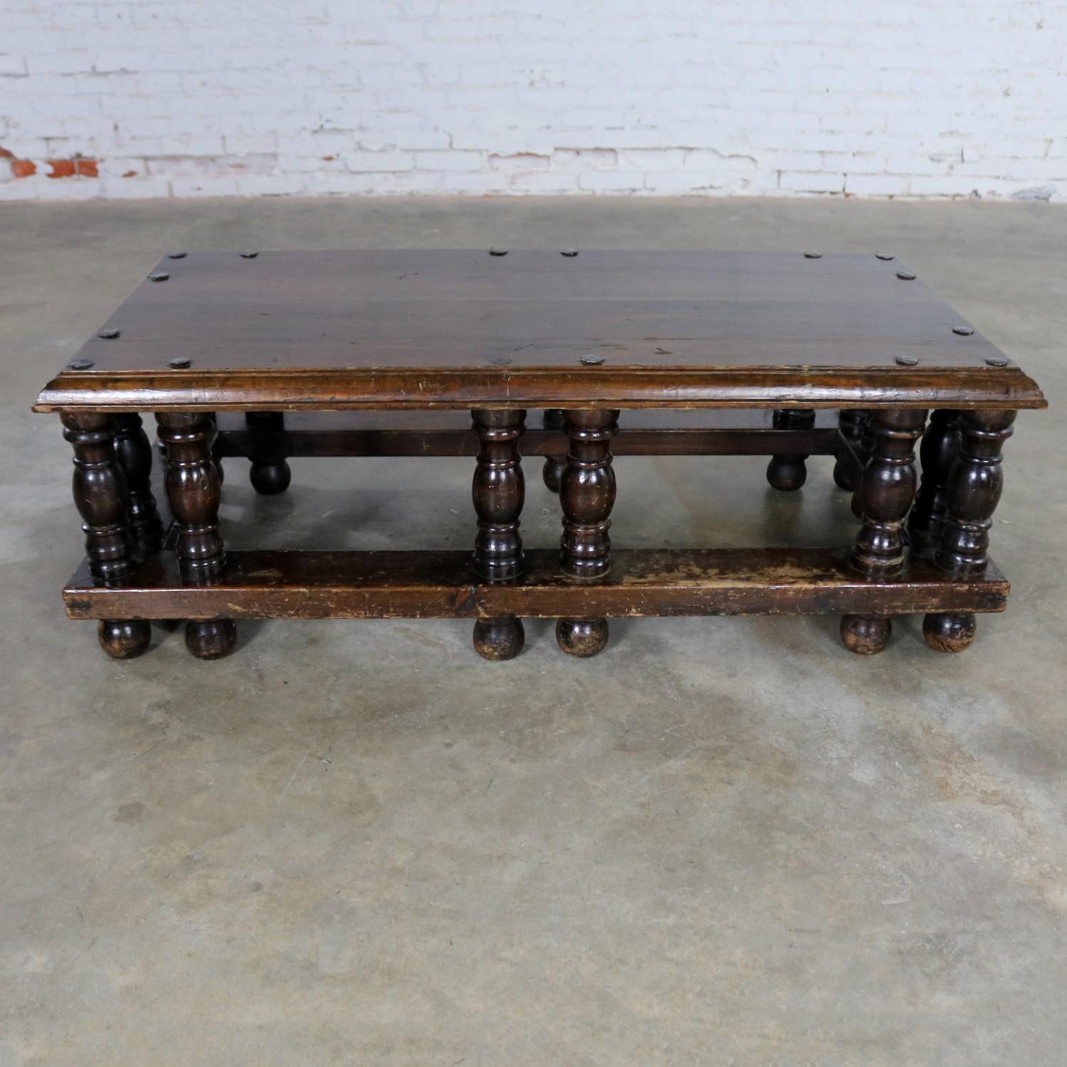 Incredible Spanish Revival style rectangular coffee table attributed to Artes De Mexico Internacionales, SA. It is in wonderful vintage condition with hand hammered metal extra large nail heads, turned legs, and lots of age patina with its original