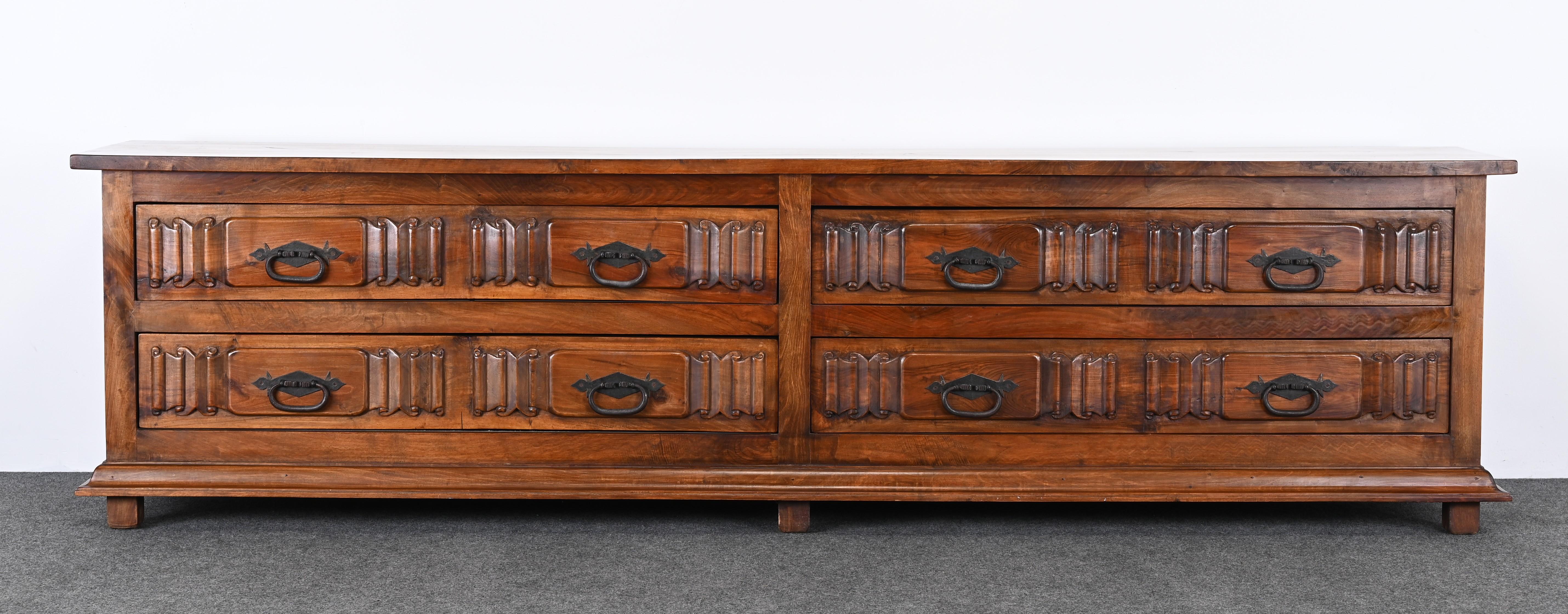 A magnificent Spanish Revival or Colonial Revival Three Piece Dresser. This amazing cabinet is made of solid black walnut accented with wrought iron hardware. The cabinet has twelve drawers for ample storage. The chest of drawers comes with two