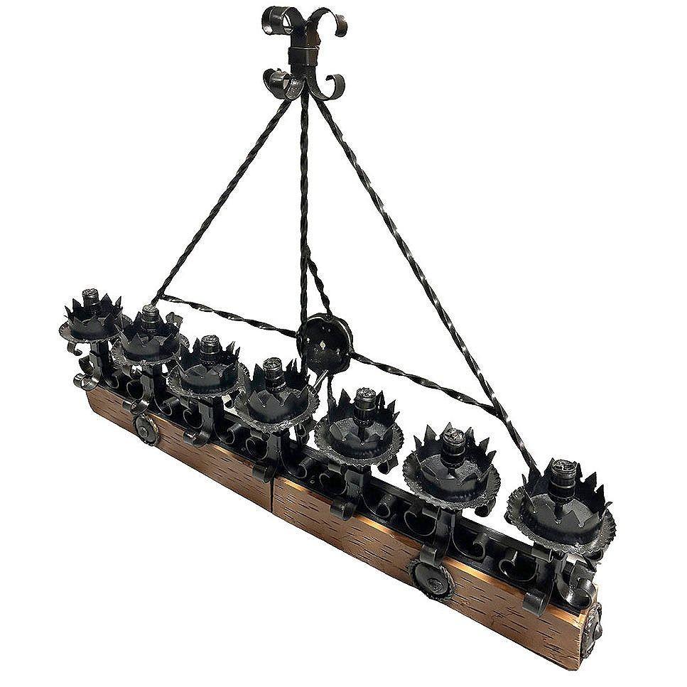 This Spanish Revival/ Medieval revival-style wrought Iron Seven-Light wood beam wall sconce showcases an elegant Fleur de Lys motif, exuding historical charm and robust craftsmanship. The wall sconce, meticulously crafted from black forged iron,