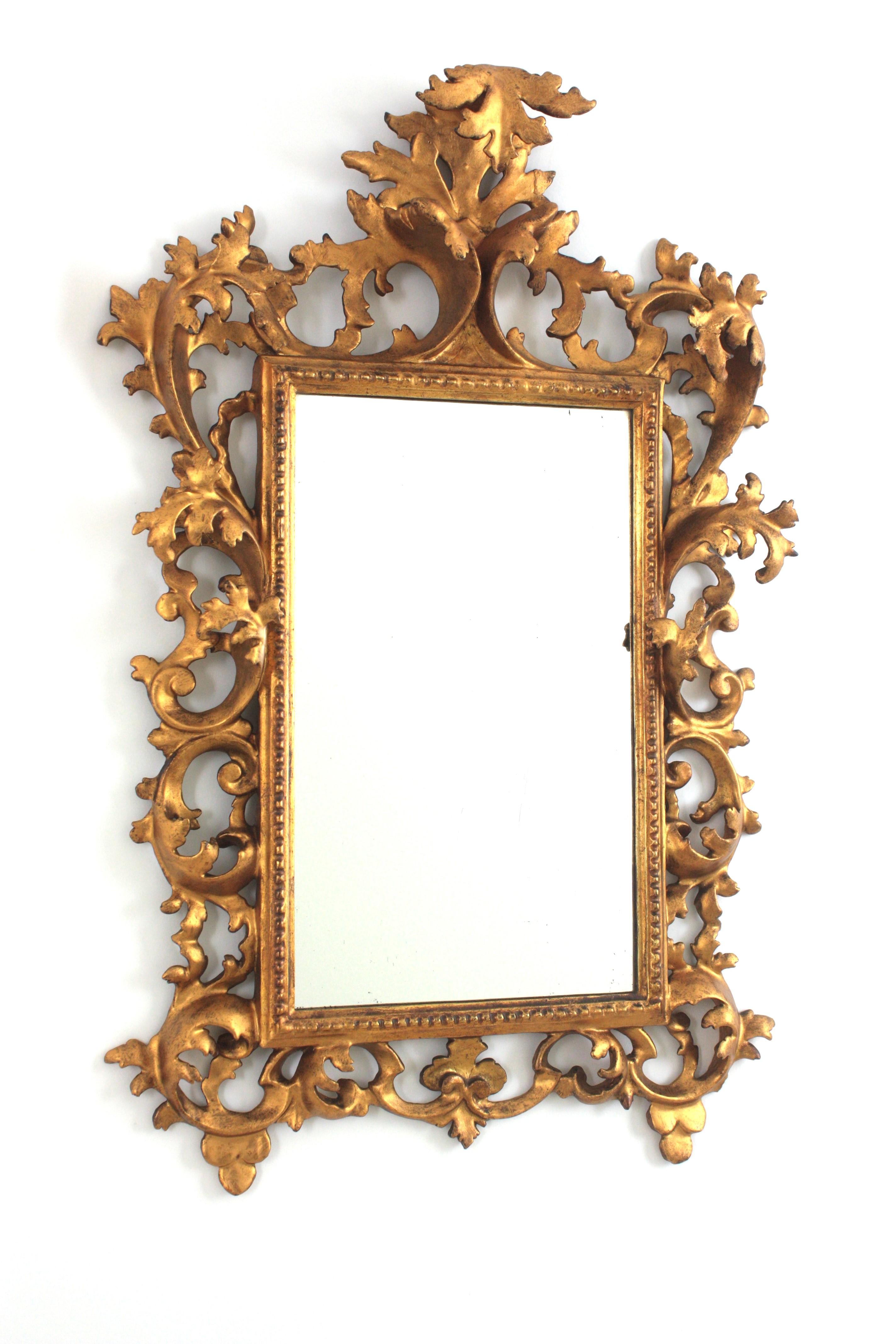 Rococo Finely Carved Giltwood Mirror with Crest, Spain, 1930s
Outstanding wall mirror with richly carved frame and gilt patina.
This fine rococo mirror has a foliage design showing deep carved details of acanthus leaves on the frame and beautiful
