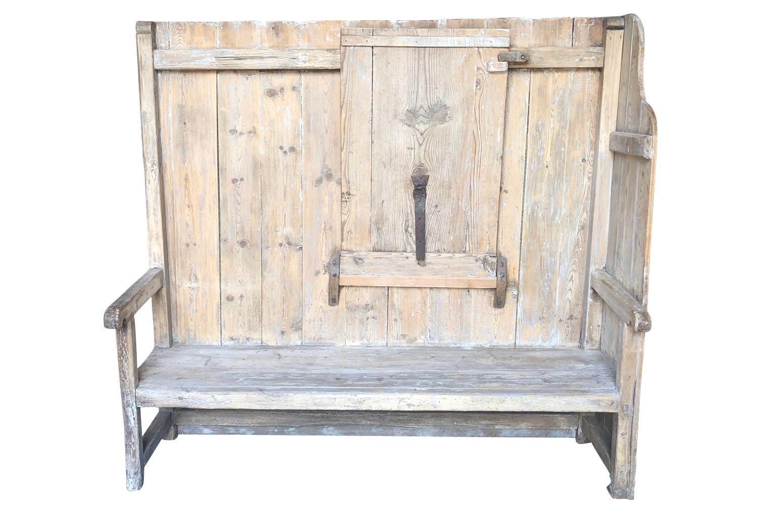 A very wonderful 18th century high back bench from the Catalan region of Spain. This terrific bench has a tabletop that folds down. Soundly constructed from naturally washed pine. This bench will add charm to its surrounding.