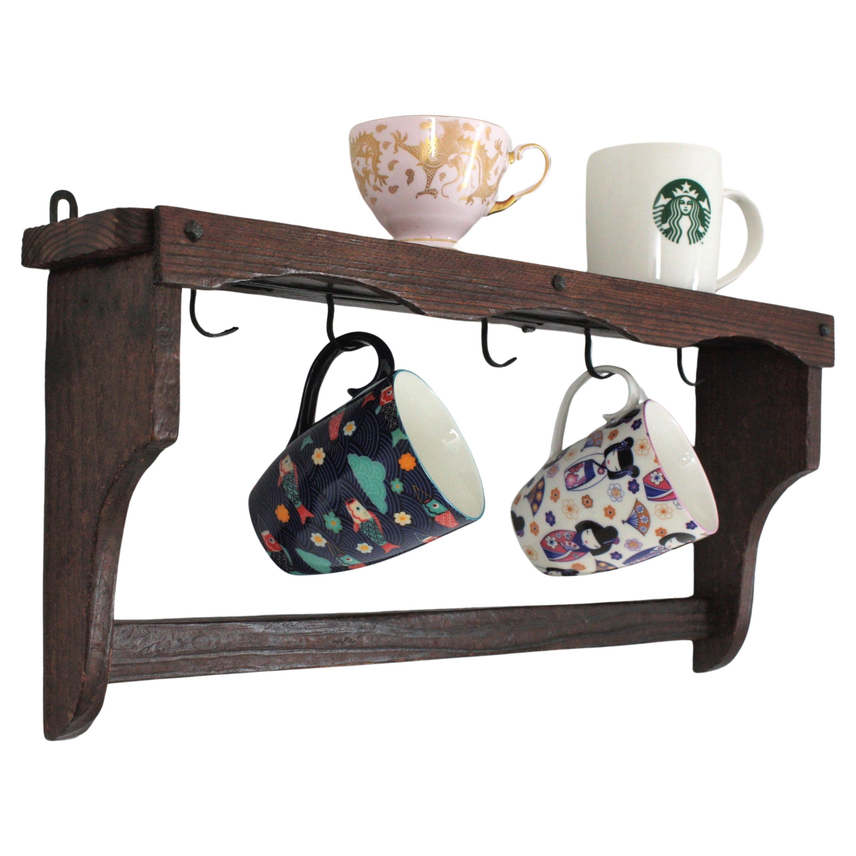 Scaffale da parete per tazze da caffè in Wood Coloni spagnolo
Mensola da parete in pino intagliato a mano per tazze e tazzine, Spagna, anni '40-'50
Questo scaffale in legno realizzato a mano  ha 5 ganci per appendere le tazze e un ripiano superiore