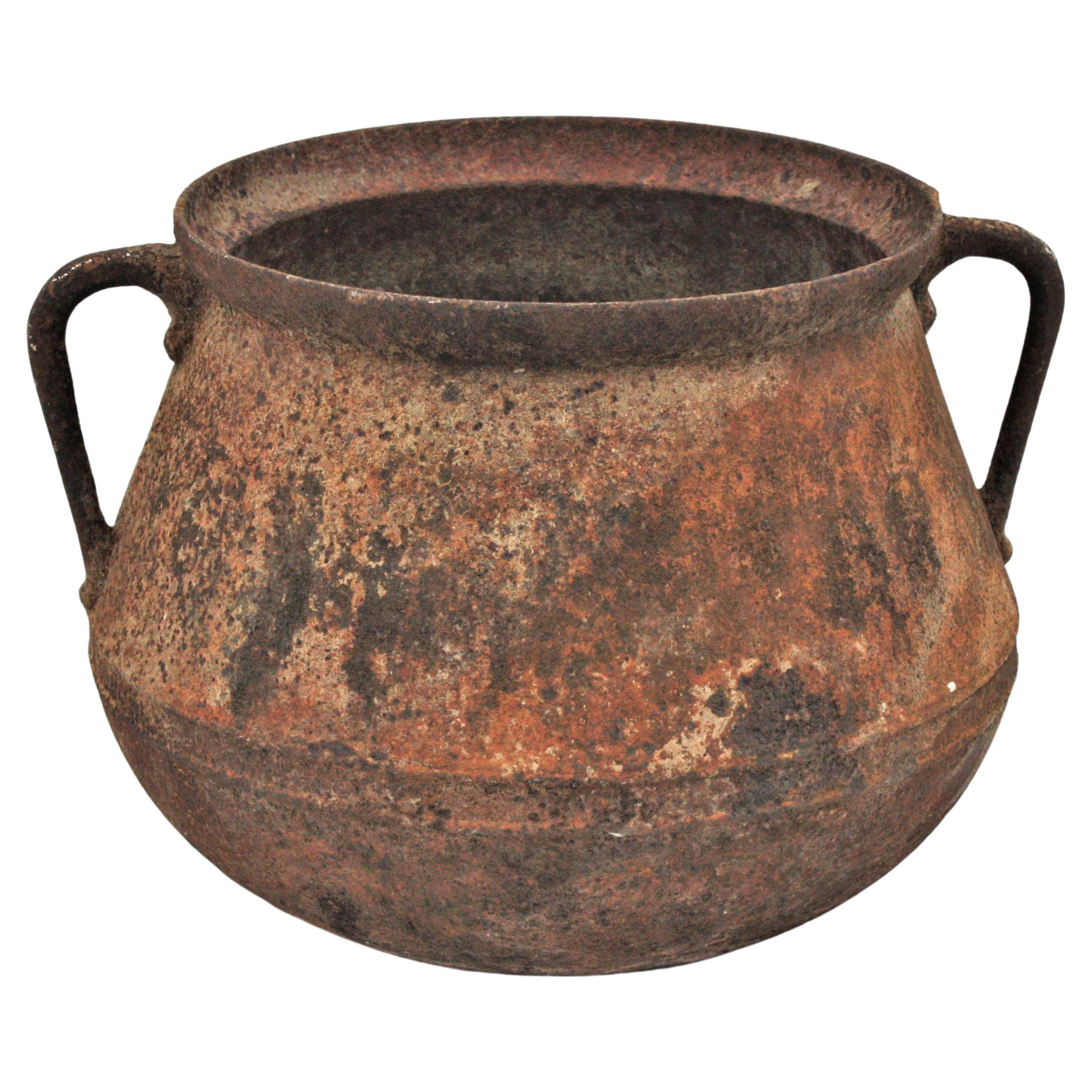 Primitive Rustic Iron Cauldron from the northern part of Spain, 1920s
Made in molded cast iron, originally used for cooking. 
This iron vessel is heavily constructed, it is strong and sturdy and it has a terrific aged patina showing a rusty
