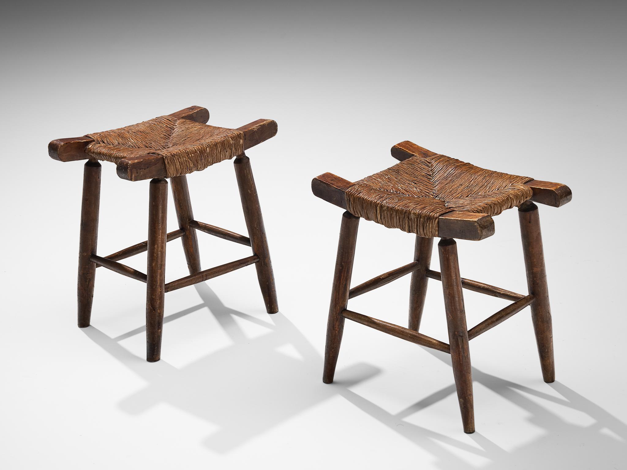 Stools, stained beech, straw, Spain, 1950s.

This piece of furniture embodies an evolved provincial character with great quality of elegance. The sincere construction and type of upholstery, give the chair a character of its own. The seat features