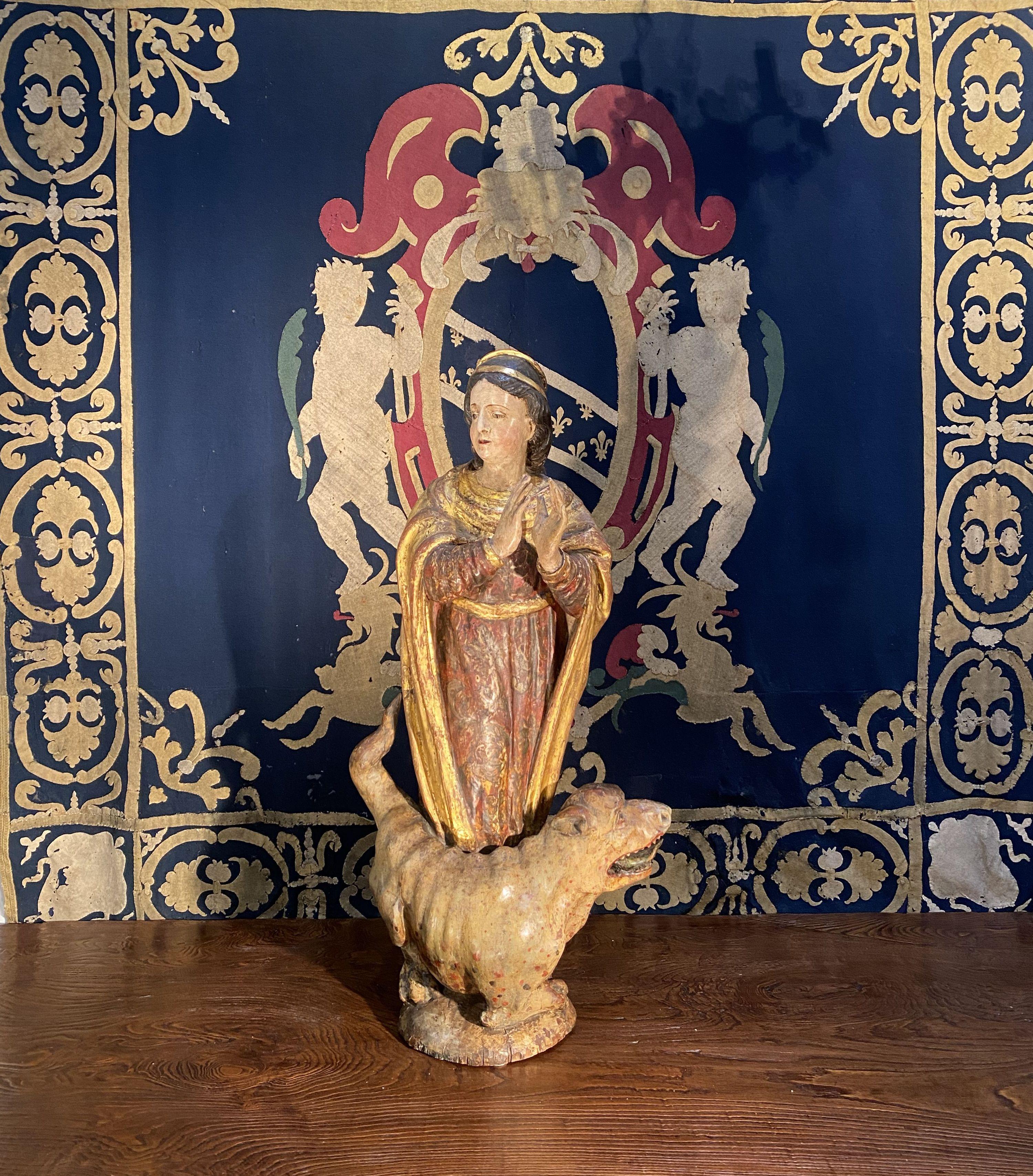 Spanish Santa Margherita with Dragon hand carved wood sculpture. 
Beautiful original polychrome especially on the dog figure which is an example of a mythical Renaissance medieval dragon. 
During the Middle Ages, St. Margherita was grouped with 13