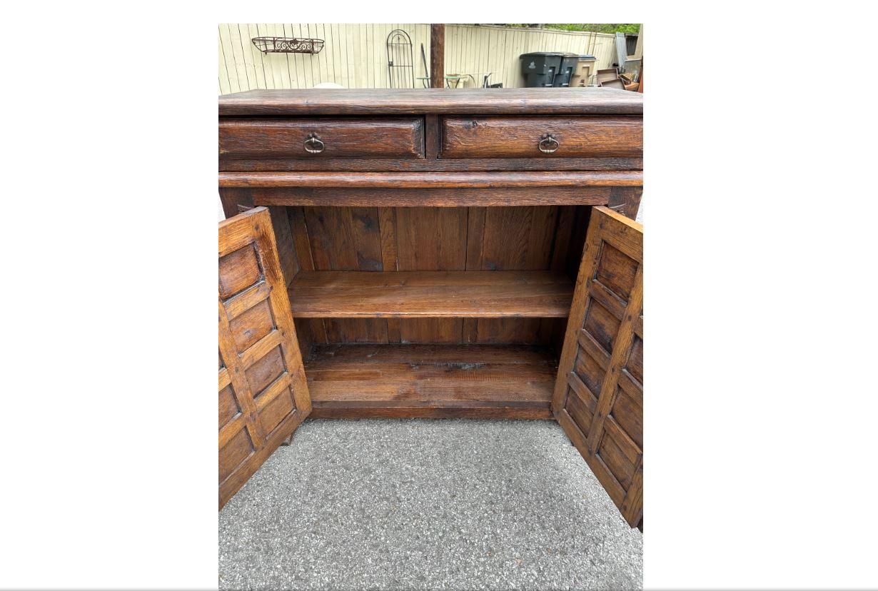 Mix it up with this 19th century Spanish server. It's small yet bold carved wooden doors are a great way to add character to your space without taking up too much real-estate making it great for any home!