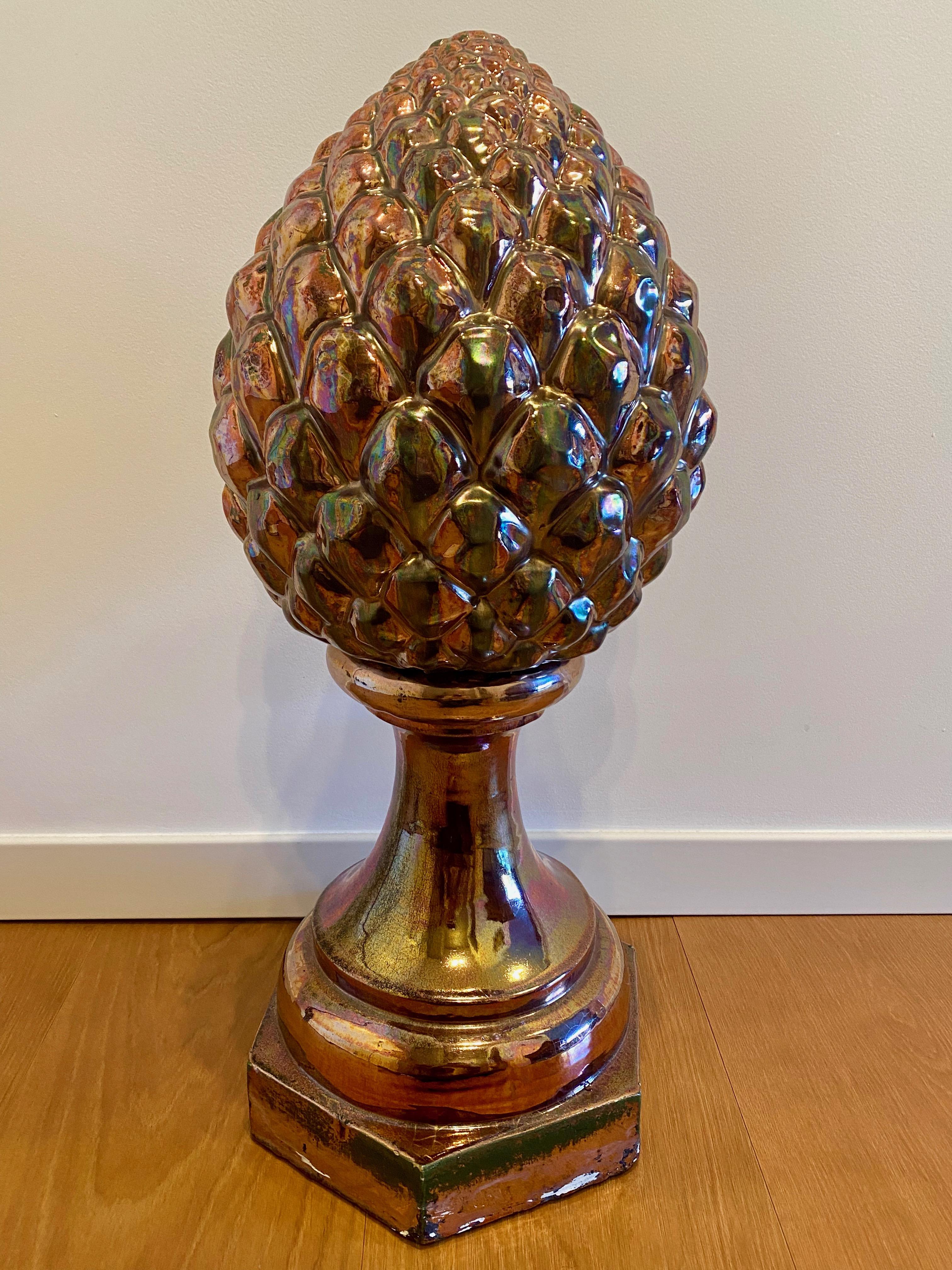 Spanish Sevillian Lustreware Triana Pottery Pine Cone, Late 19th Century

This beautiful ceramic object in the shape of a pine cone is glazed with mainly iridescent red color tones,
datable to around the end of the 19th century. This example of