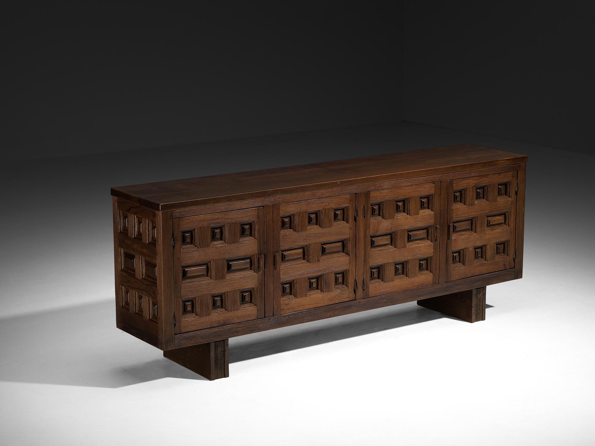Sideboard, pine and walnut, Spain, 1970s

Beautiful Spanish sideboard with geometrical front, made in pine and walnut wood. The door panels feature carved squares, typical for Brutalist style, while the type of pattern has references to