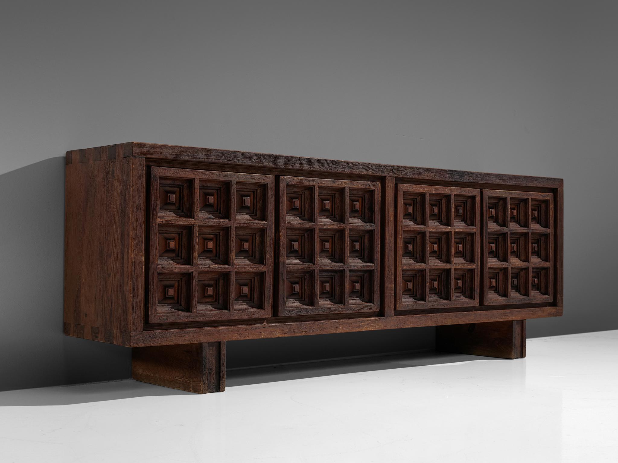 Biosca, sideboard, stained pine, Spain, 1960s.

Outstanding Spanish sideboard that is executed by Biosca in a beautiful way. The four-door credenza features doors with a graphic carved pattern. This is very typical for Brutalist style, while the