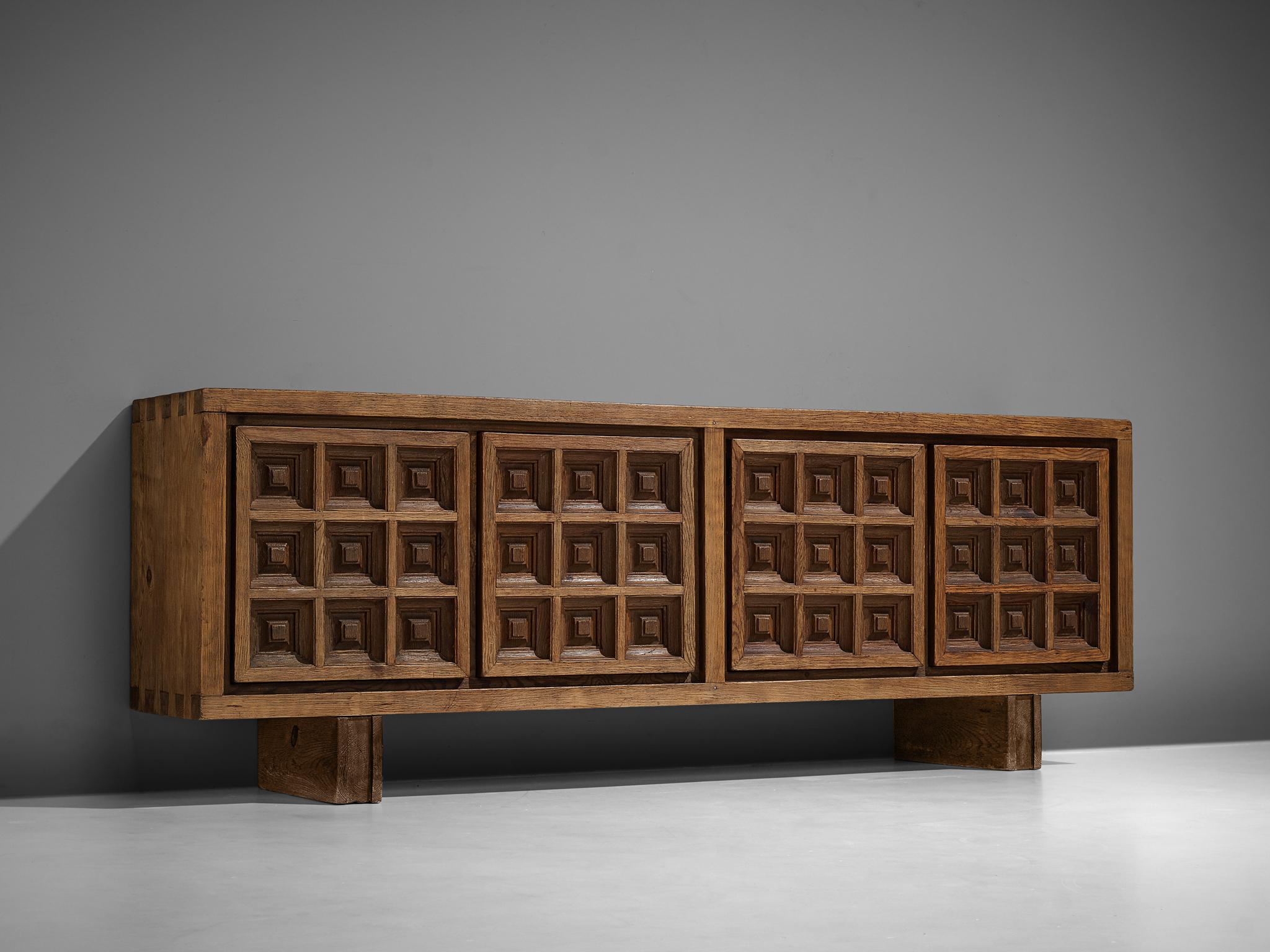 Biosca, sideboard, stained pine, Spain, 1960s

Outstanding Spanish sideboard that is executed by Biosca in a beautiful way. The four-door credenza features doors with a graphic carved pattern. This is very typical for Brutalist style, while the type