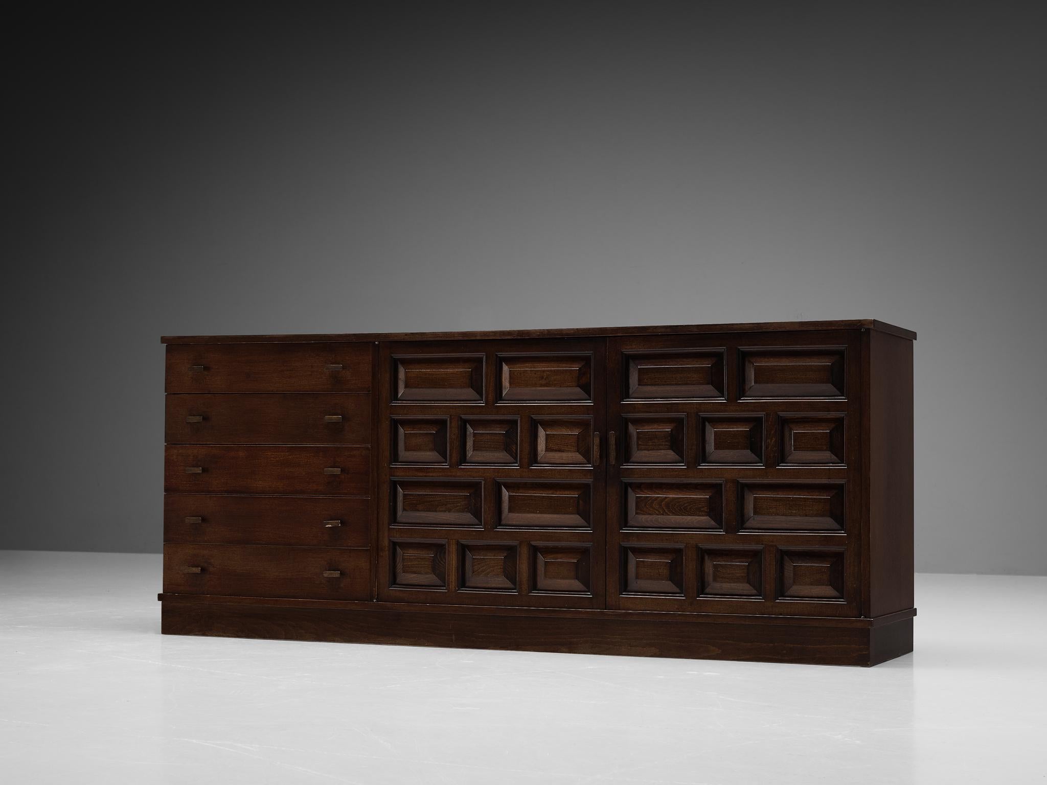 Sideboard, stained oak, metal, Spain, 1960s. 

Outstanding Spanish sideboard that is executed in beautiful dark stained oak in patinated condition. The two-door cabinet with five doors features doors with a graphic carved pattern. Note the