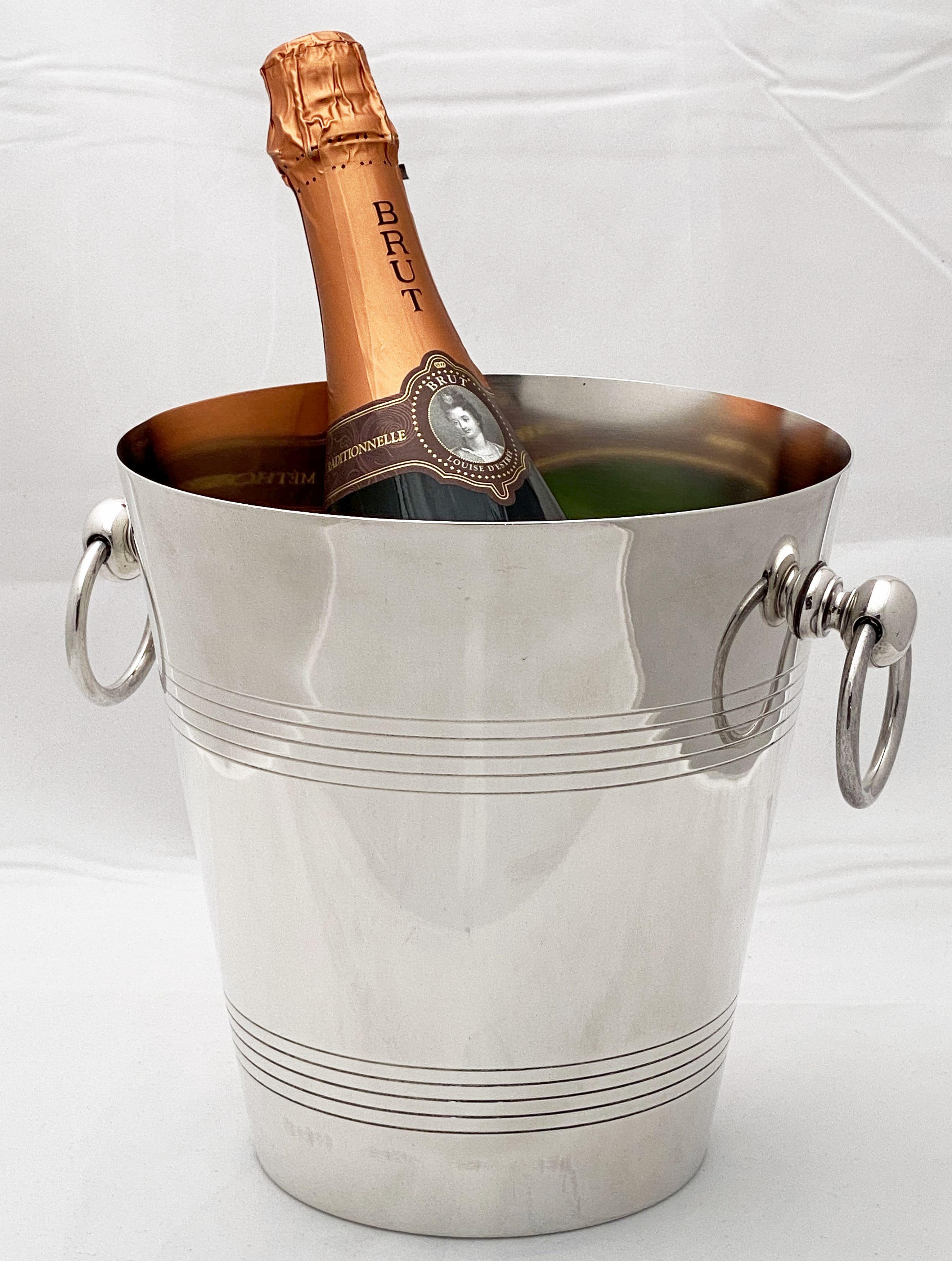 A fine Spanish champagne bucket or wine cooler of fine plate silver, featuring two stylish opposing ring handles, concentric circle design around the circumference, and an elegantly tapering body.

Impressed hallmarks on base.
   