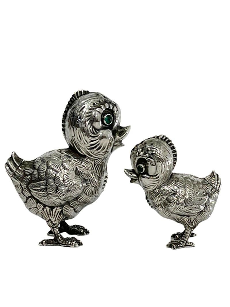 Spanish Silver salt and pepper shakers in the shape of chicks, 1940s

Lovely chicks with their green eyes as shakers for salt and pepper
The tail of the chicks has a screw thread, which can be opened to fill with salt or pepper
Made in Spain,