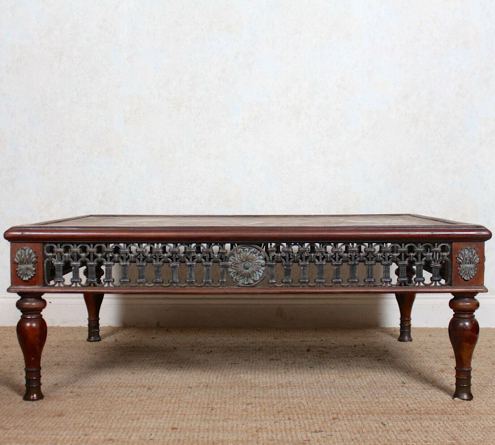 An impressive marble topped mahogany console table.
The rectangular top with marble insert and shaped edges above a pierced metal frieze with ferrules and raised on turned tapering legs,
Spain, circa 1970.