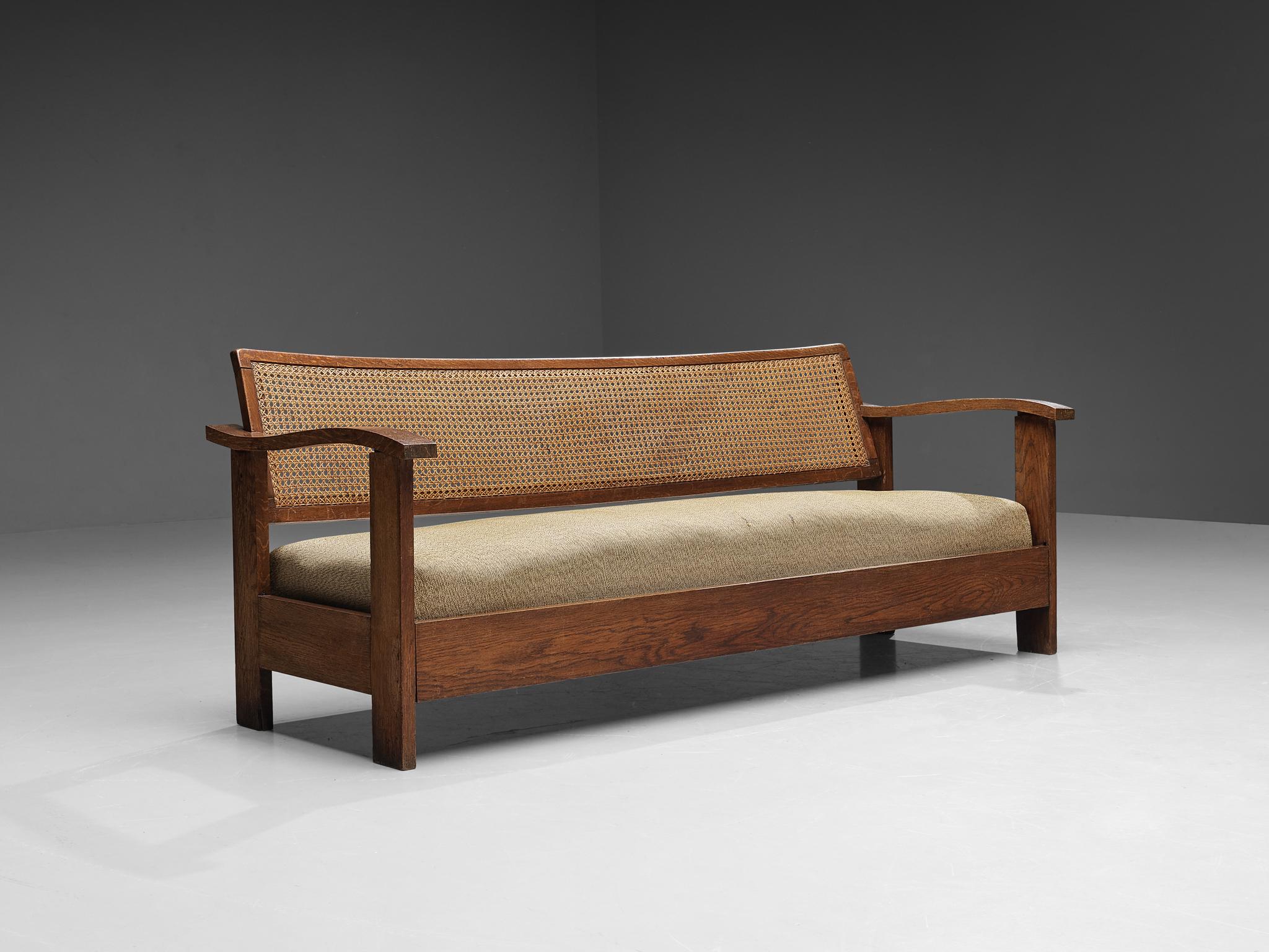 Josep Palau Oller, sofa, oak, cane wicker, fabric, Spain, 1930s. 

Beautifully constructed sofa of Spanish origin designed by Josep Palau Oller (1888-1961). The design embodies an evolved rustic character with great quality of elegance. The backrest