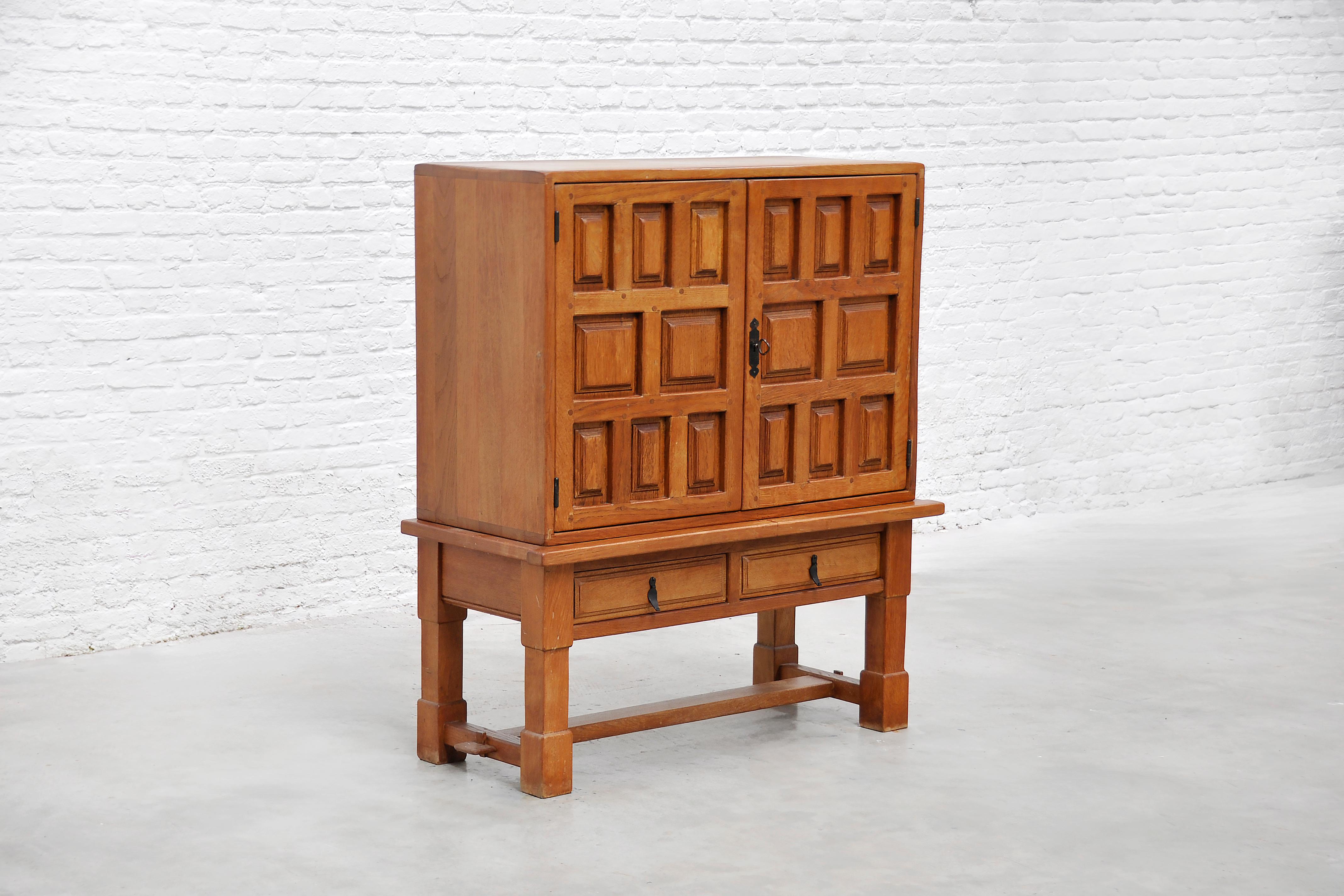 Hand-crafted in Spain in the early 1940s, this sculptural bar cabinet epitomises Brutalist design. Thick planks of solid oak are relief-carved in an irregular, geometric pattern that gives the front a striking three-dimensional presence. Patinated