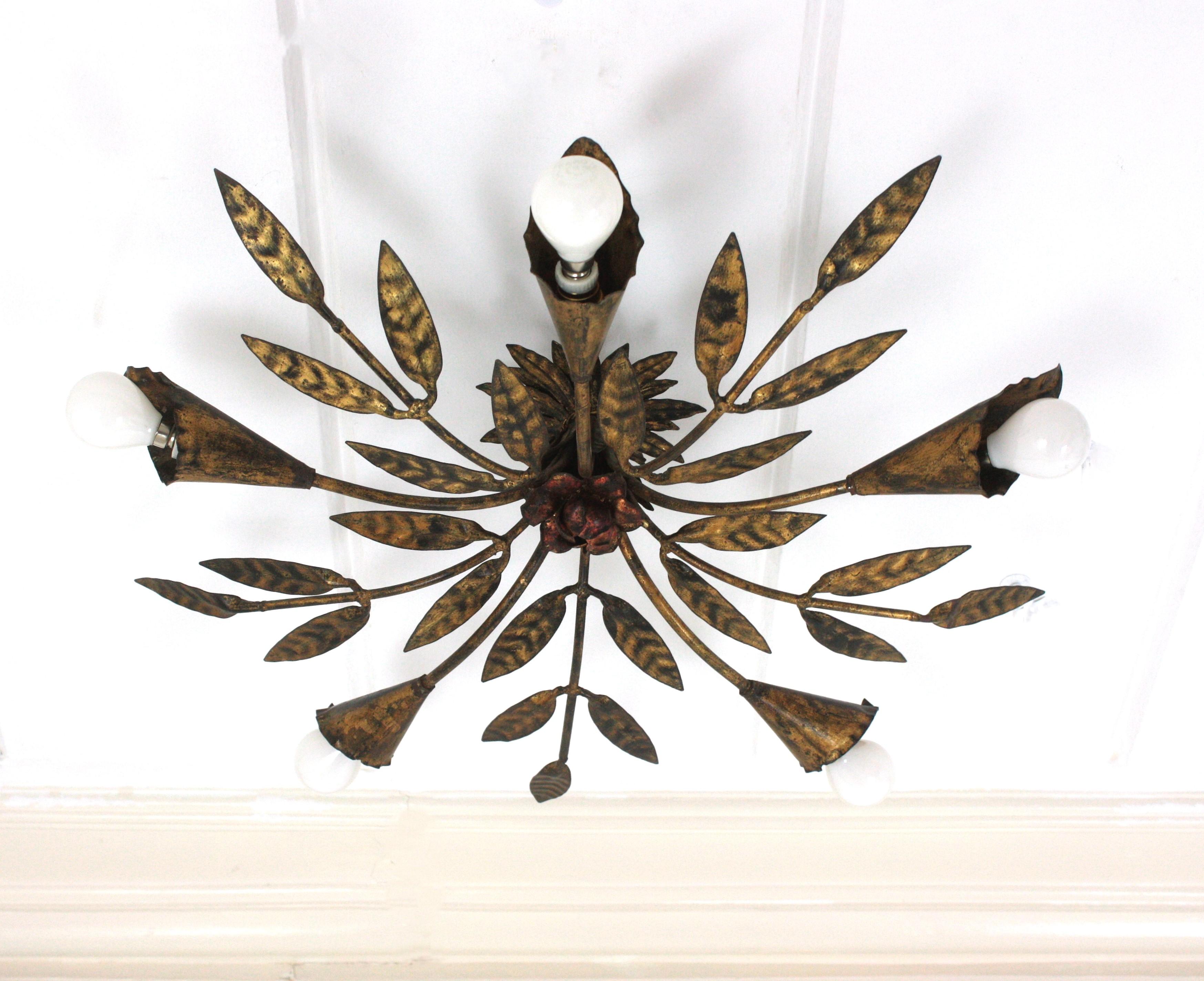 Outstanding spanish foliage sunburst flush mount ceiling light in gilt iron, Ferro Art, 1950s
To be used as ceiling light fixture or as chandelier / pendant light adding a chain to the desired height.
This five-light ceiling lamp features an