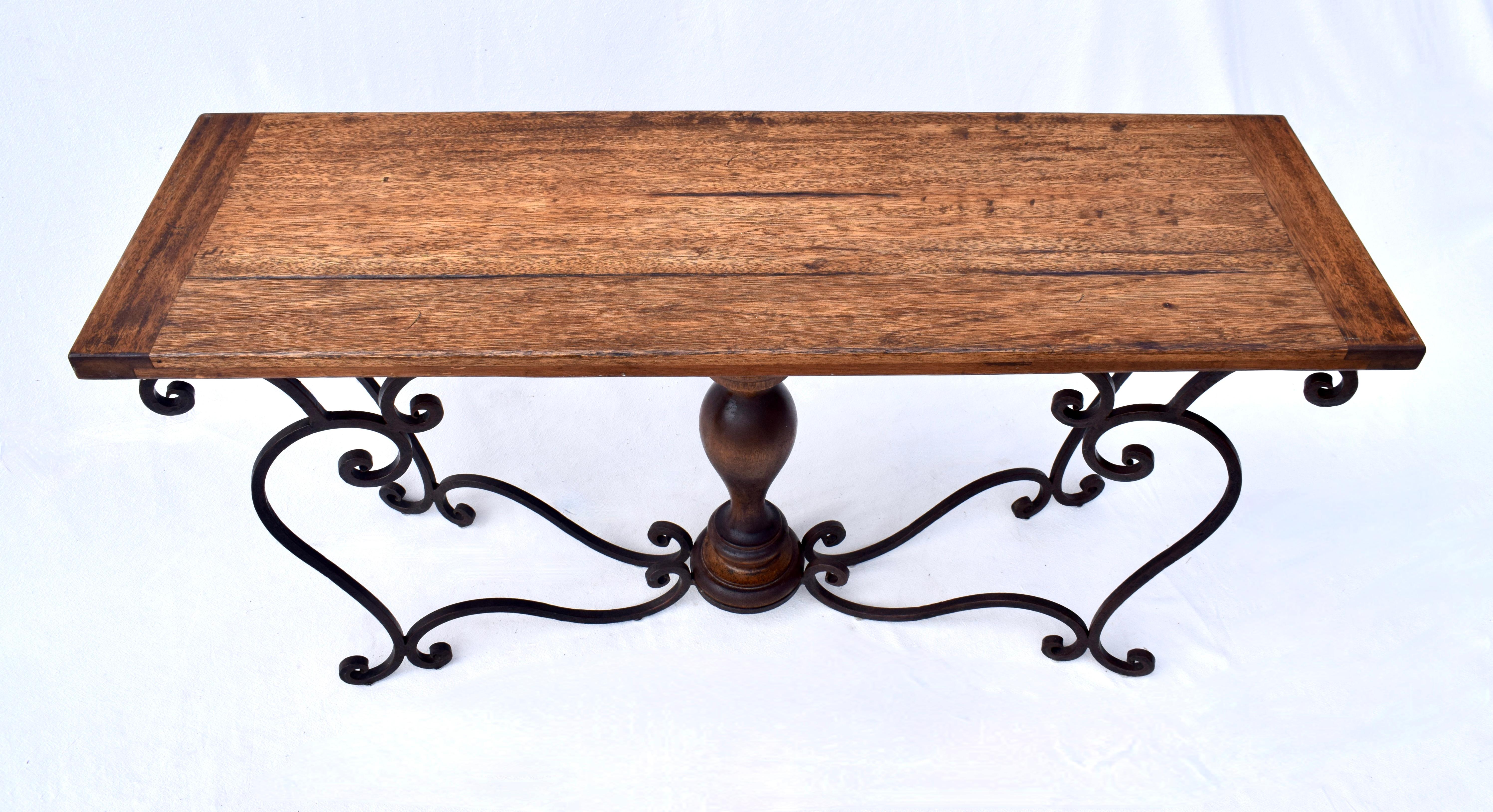 Studio forged iron console table with solid Mahogany breadboard top, turned inlay vase shape center, distinctly Spanish in style. Beautifully maintained of substantial construction; ready for use.