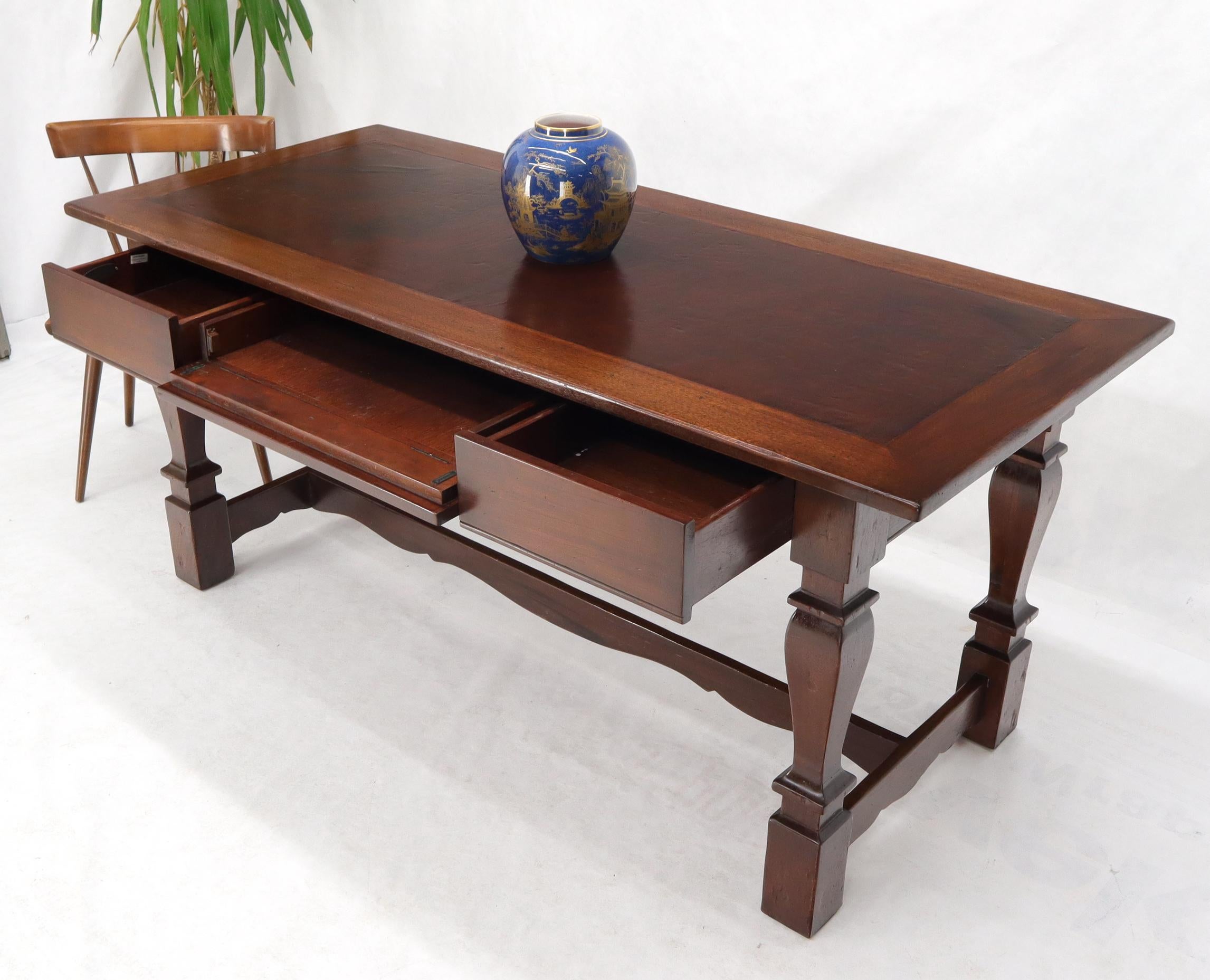 Farm style stretcher heavy legs leather top writing table desk with three drawers. Outstanding craftsmanship and materials.