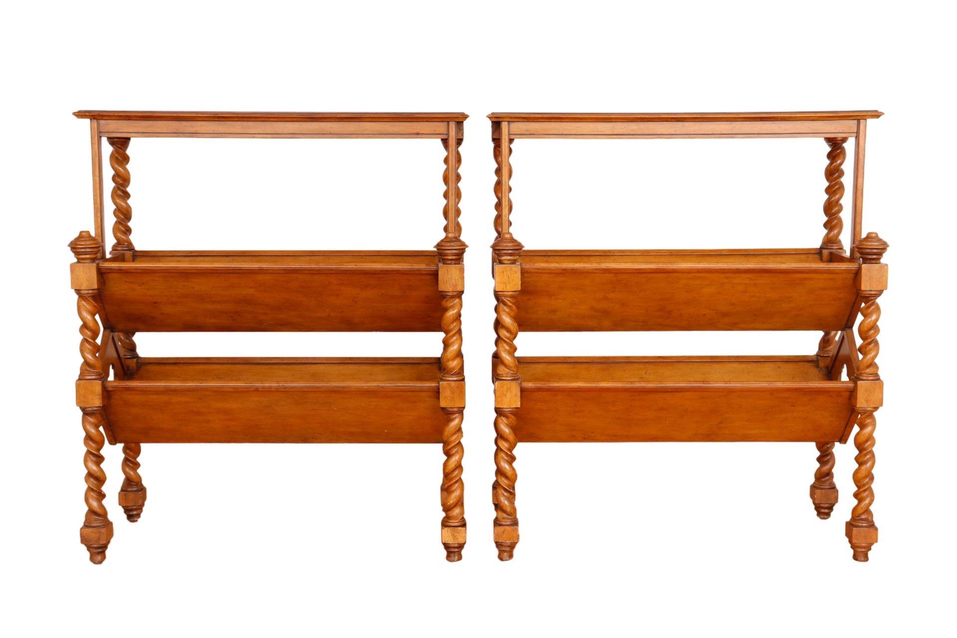 A pair of Spanish Baroque style library bookcases in maple. Barley twist legs support two v shaped shelves, decorated at each end with quatrefoil pierced panels. Dimensions per bookcase.