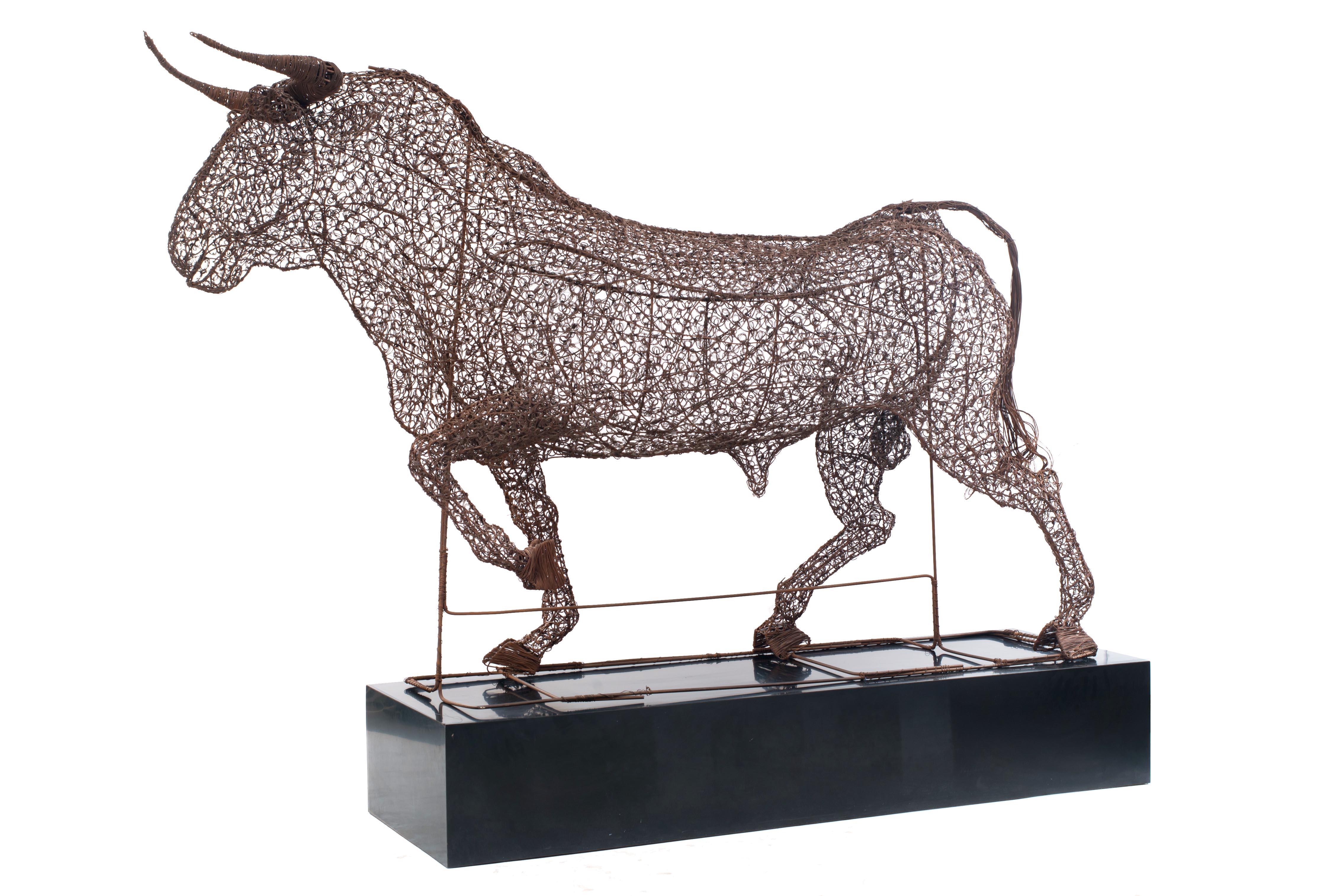 Spanish-style life size wire bull figure resting on a black plinth (1950s).
     
