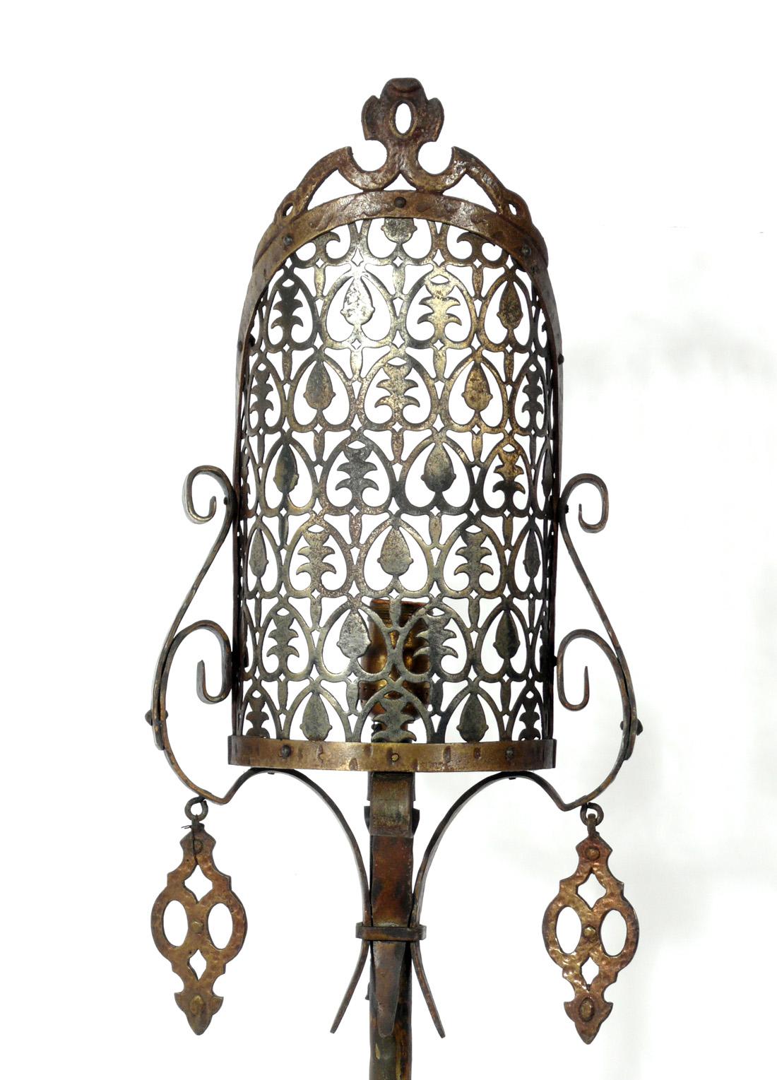 Spanish style metal floor lamp, attributed to Oscar Bach, American, circa 1930s. Retains warm original patina. It would be perfect in your California or Mexican hacienda. It has been rewired and is ready to use.