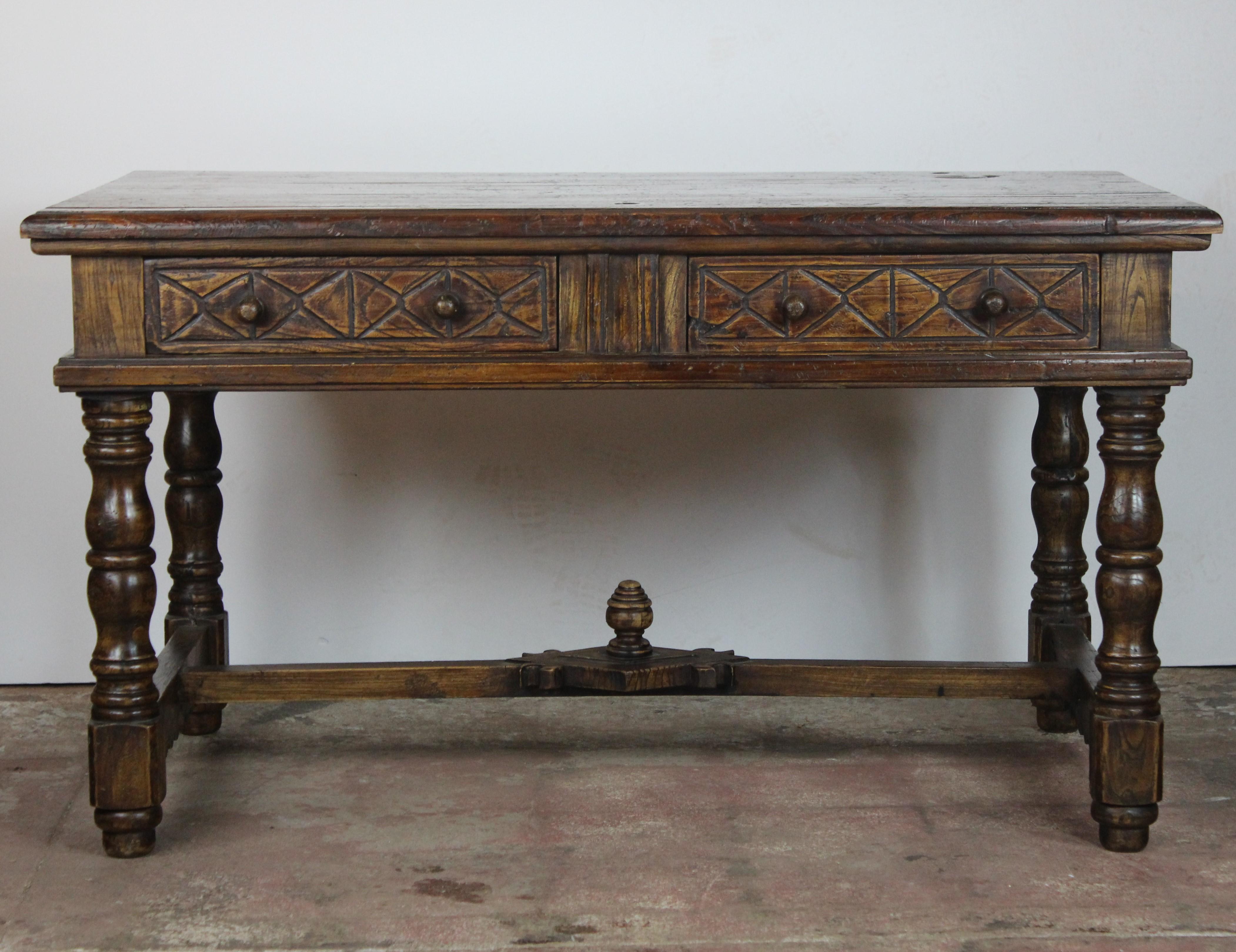 Spanish style writing table with carved stretcher and two drawers. Floor to skirt 21.50