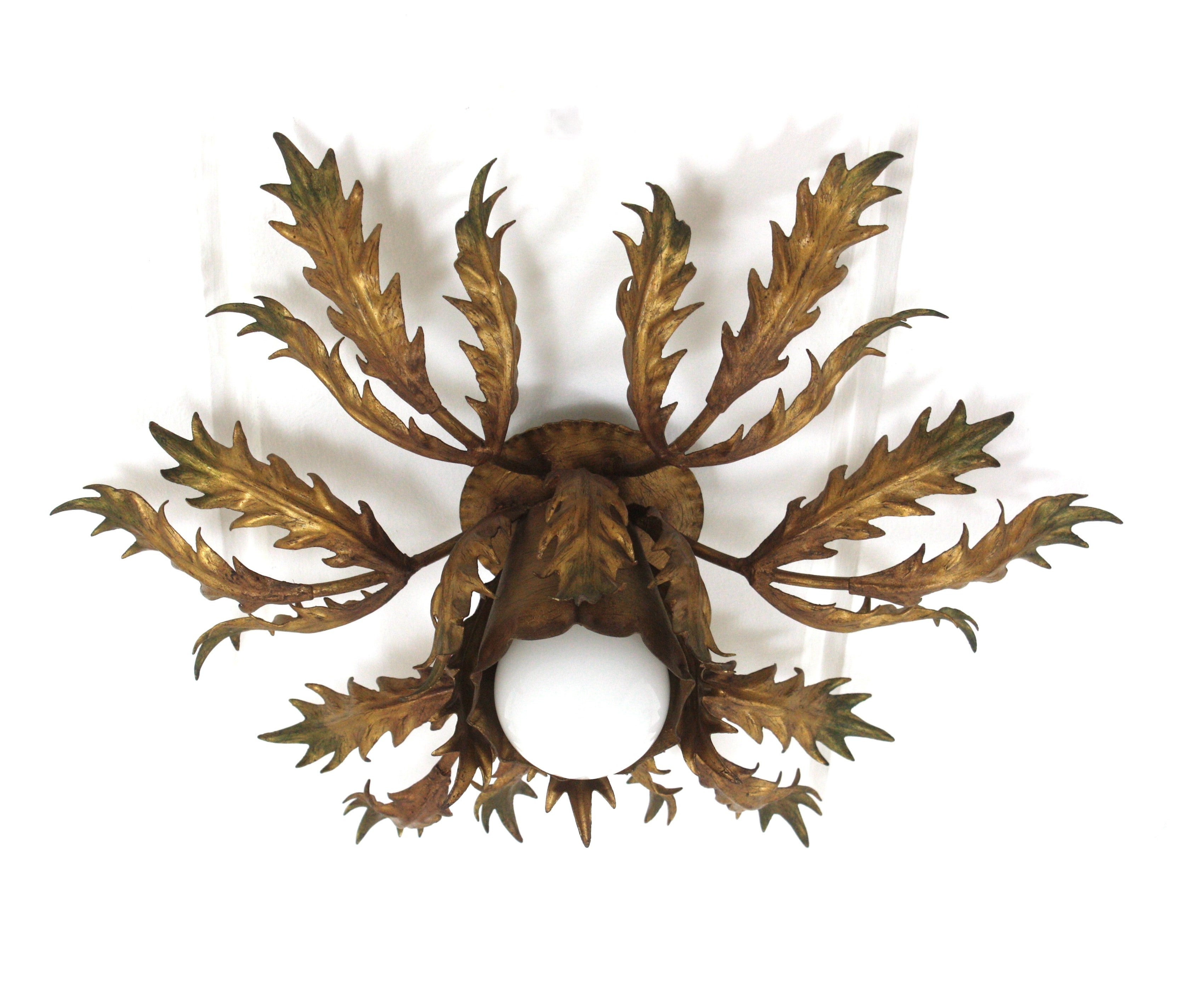 Gilt Iron Leafed Sunburst Light Fixture
Stunning foliage sunburst ceiling light fixture, gilt iron, gold leaf, Spain, 1950s.
This eye-catching iron ceiling lamp features a double layered leafed frame of leaves surrounding a central exposed bulb.