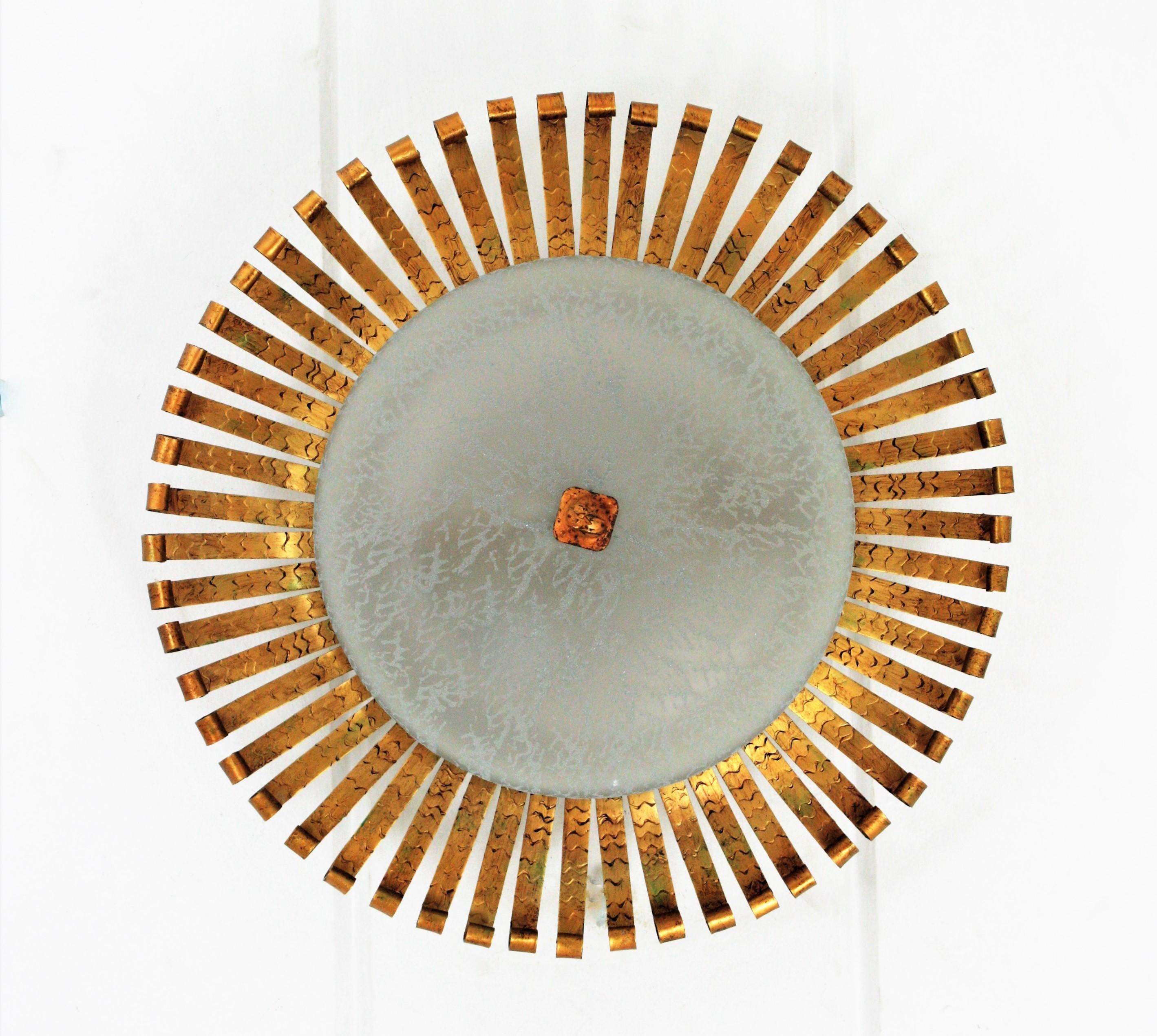 Mid-Century Modern Spanish Sunburst Light Fixture in Wrought Gilt Iron with Frosted Glass Shade For Sale