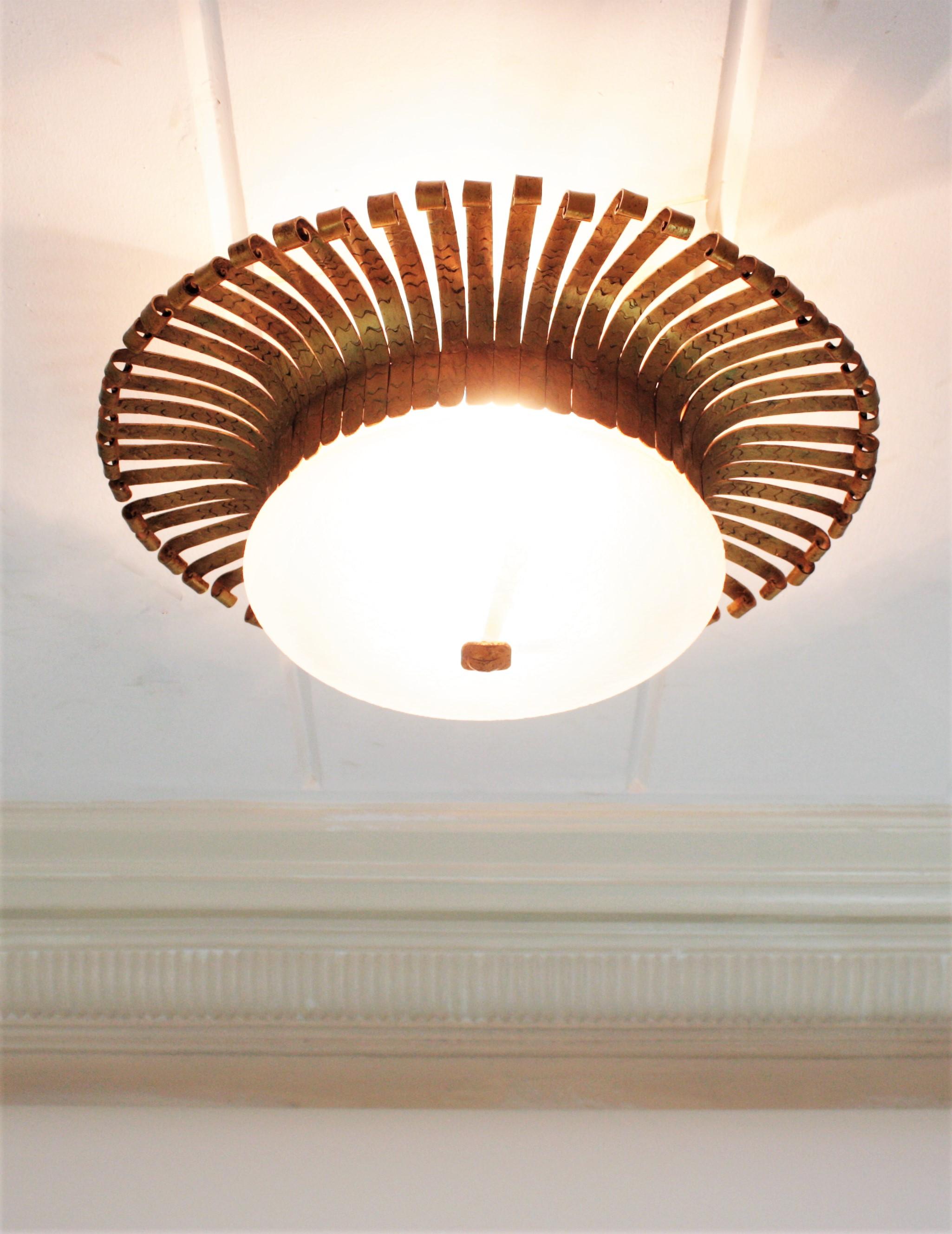 20th Century Spanish Sunburst Light Fixture in Wrought Gilt Iron with Frosted Glass Shade For Sale